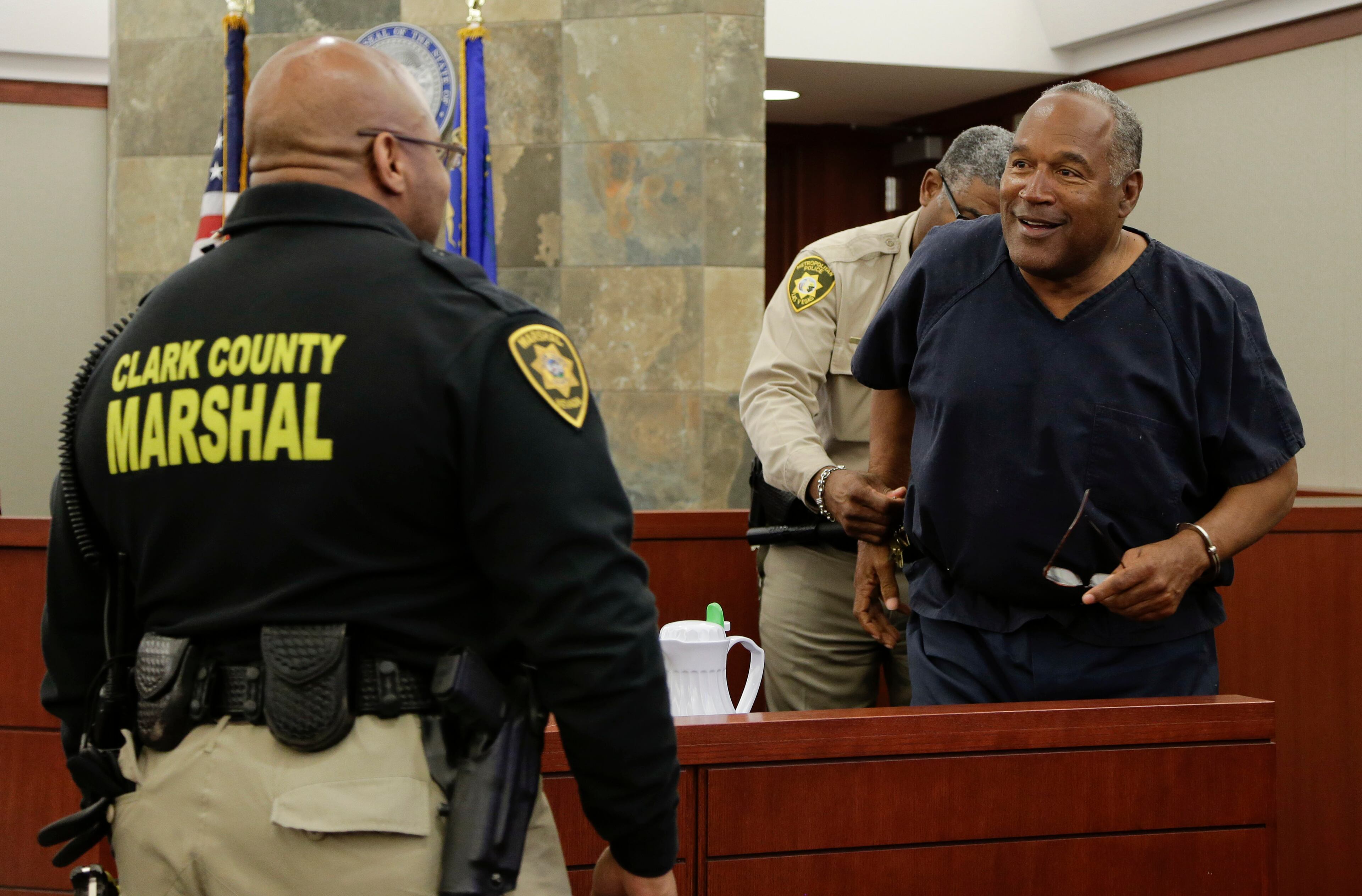 O.J. Simpson is handcuffed and escorted away from the witness stand during a break in an evidentiary hearing in Clark County District Court on May 15, 2013 in Las Vegas.