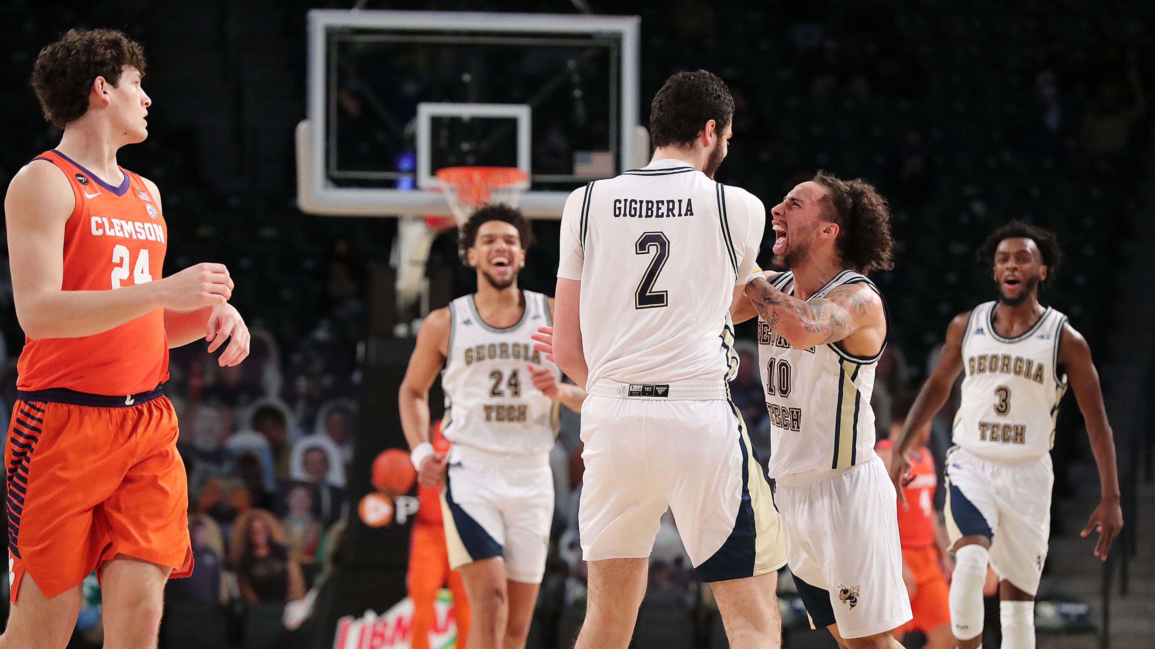 Georgia Tech center Rodney Howard (from left) looks on as Saba Gigiberia gets a chest bump from Jose Alvarado after hitting a 3-pointer against Clemson in the final minutes of a 83-65 upset victory with Bubba Parham rushing to join the celebration Tuesday, Jan. 20, 2021, in Atlanta. At left Clemson forward PJ Hall looks on. Curtis Compton / Curtis.Compton@ajc.com”
