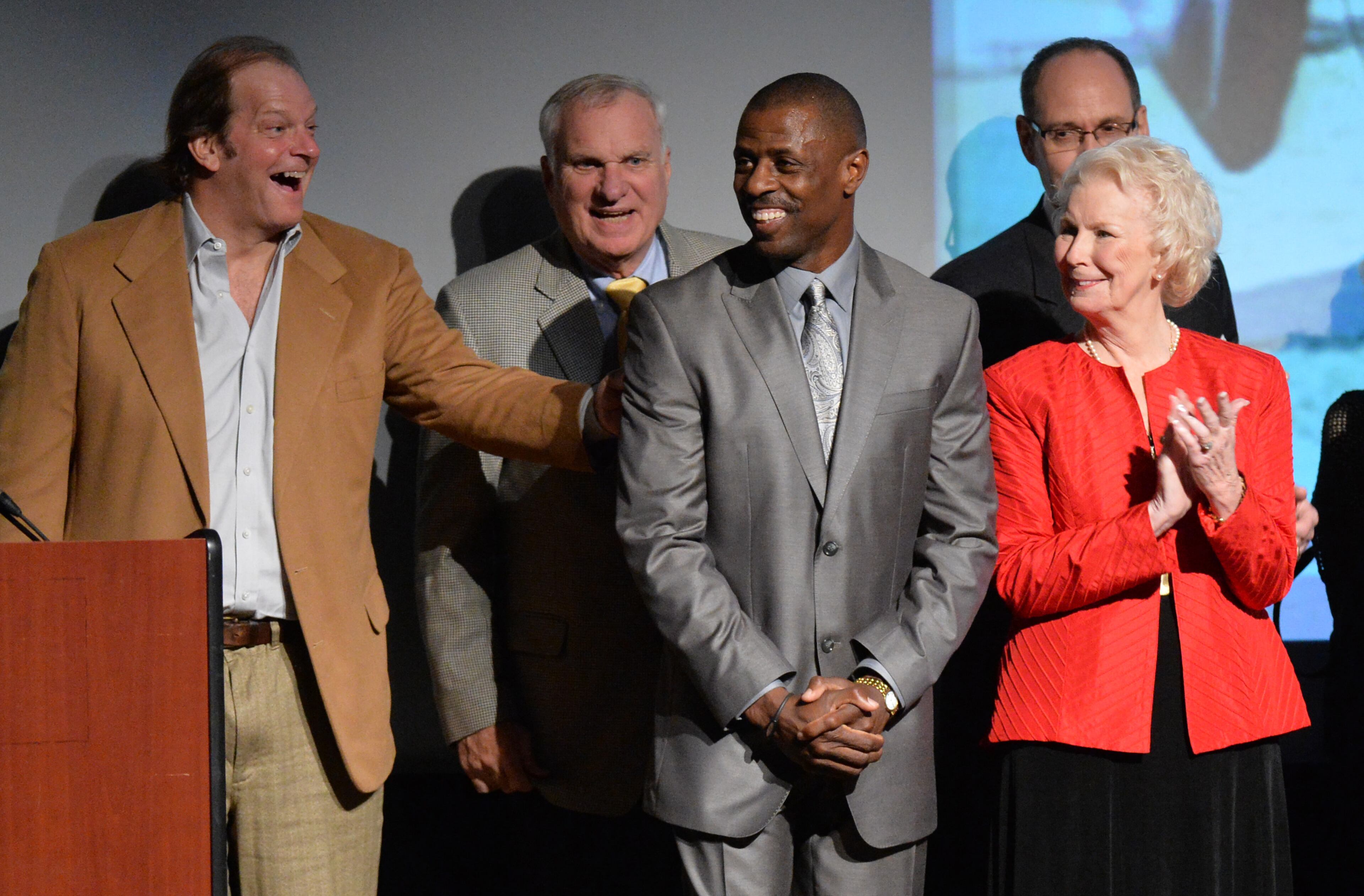2014 Inductee Antonio McKay (center) smiles as he is recognized during the Atlanta Sports Hall of Fame 10th Anniversary induction ceremony at Buckhead Theater in Atlanta on Friday, February 7, 2014.The Atlanta track and field athlete specialized in the 400 meters. Antonio McKay is a three-time All-American at Georgia Tech and Olympic medalist. HYOSUB SHIN / HSHIN@AJC.COM