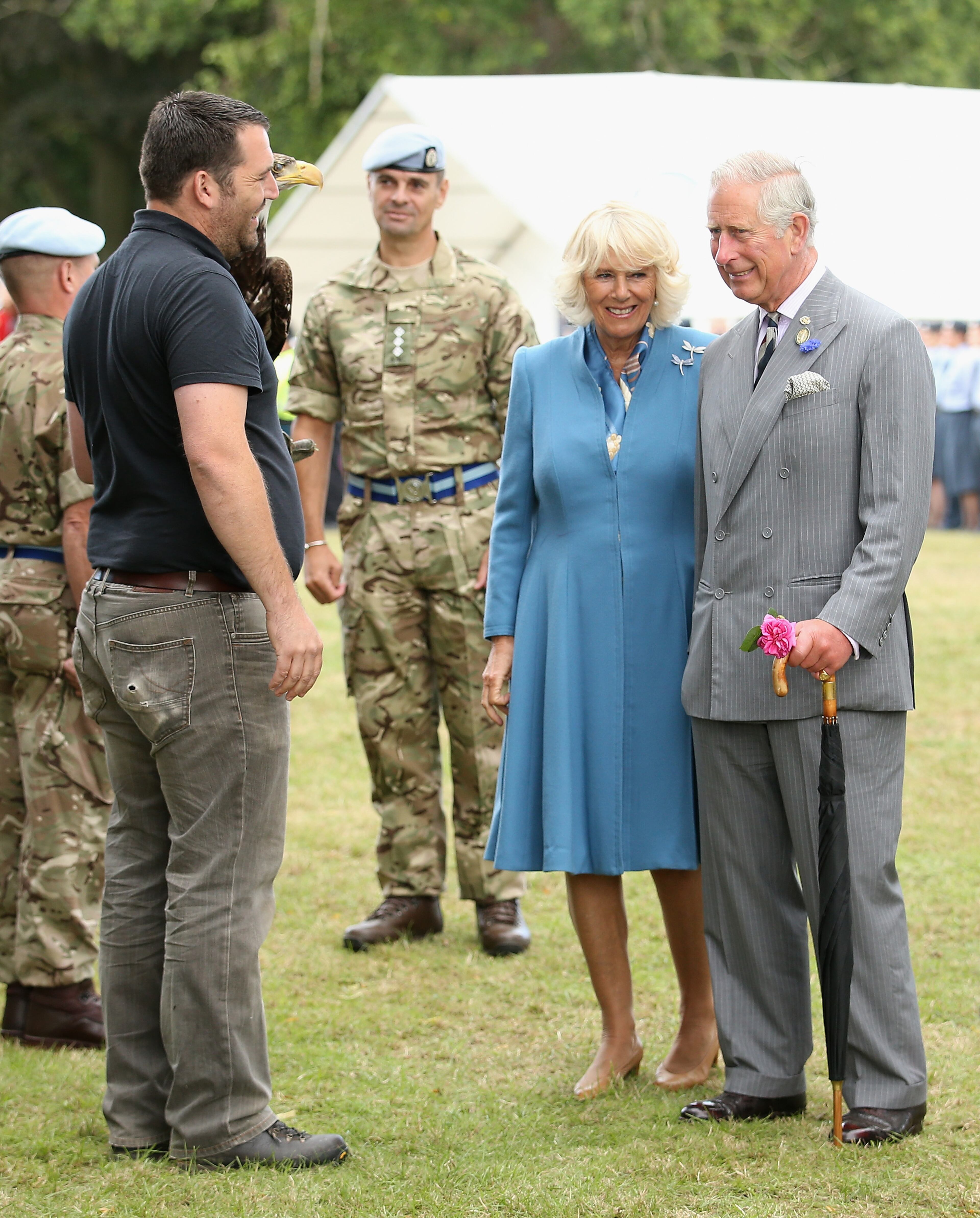 KING'S LYNN, ENGLAND - JULY 29: Prince Charles, Prince of Wales and Camilla, Duchess of Cornwall meet Zephyr (a bald eagle), the mascot of the Army Air Corps at Sandringham Flower Show on July 29, 2015 in King's Lynn, England. (Photo by Chris Jackson/Getty Images)