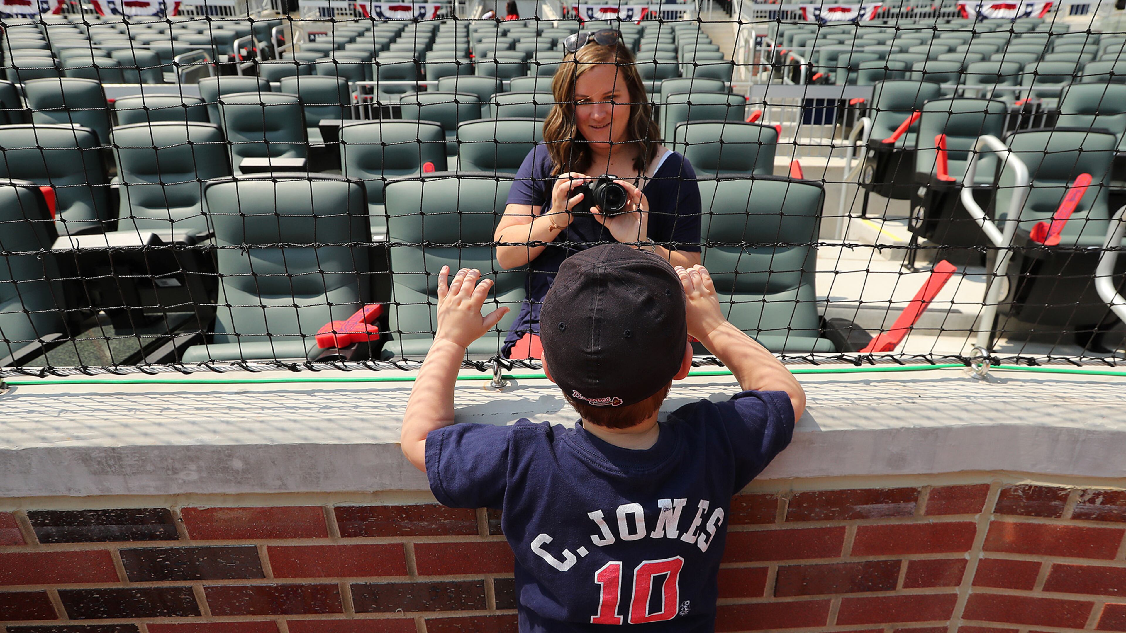 April 14, 2017, Atlanta: Braves fan Emily Jones snaps a photo of her 3-year-old son Turner behind homeplate before the home opener in the new stadium at SunTrust Park on Friday, April 14, 2017, in Atlanta. Curtis Compton/ccompton@ajc.com