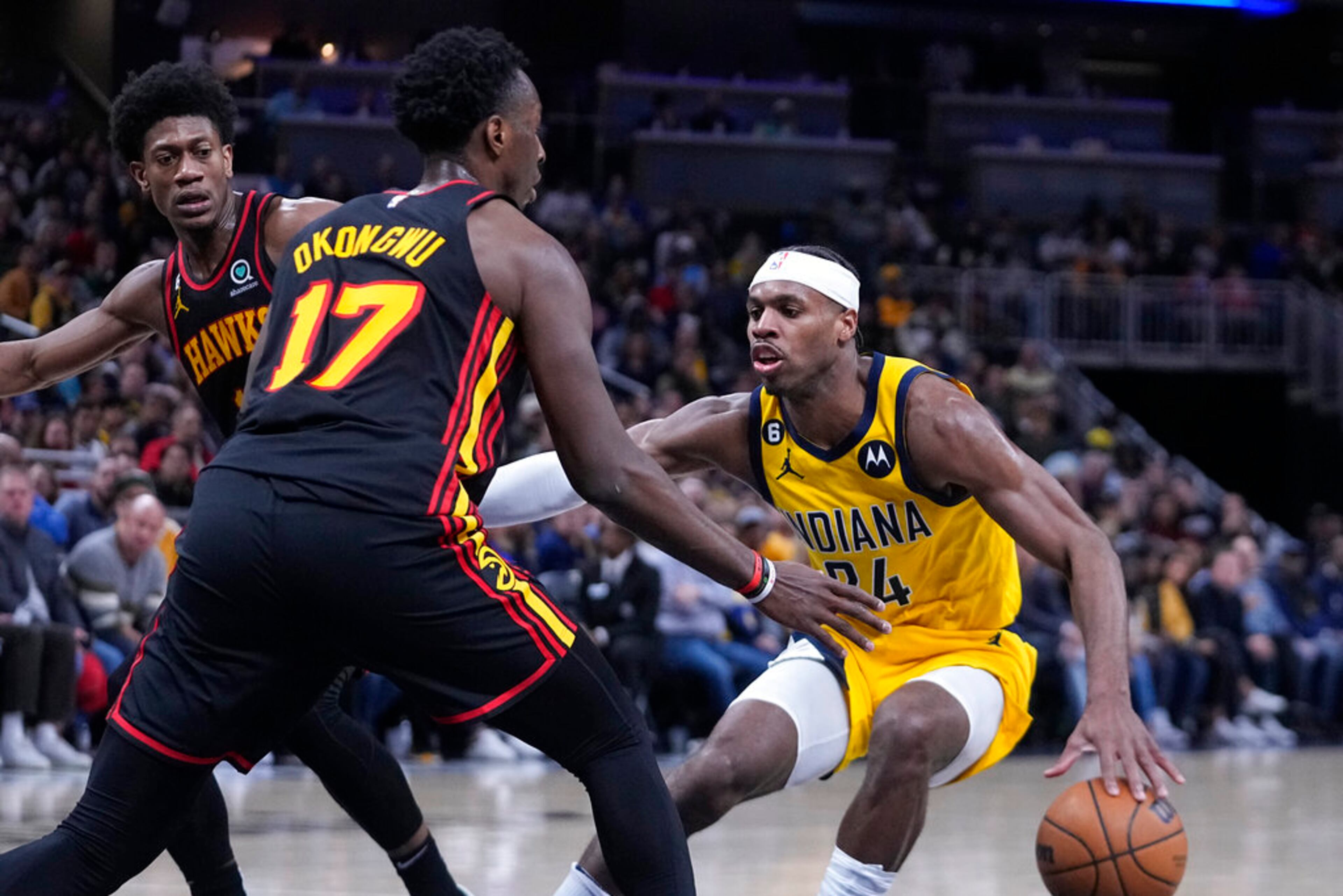 Indiana Pacers' Buddy Hield (24) is defended by Atlanta Hawks' Onyeka Okongwu (17) during the second half of an NBA basketball game Friday, Jan. 13, 2023, in Indianapolis. (AP Photo/Darron Cummings)