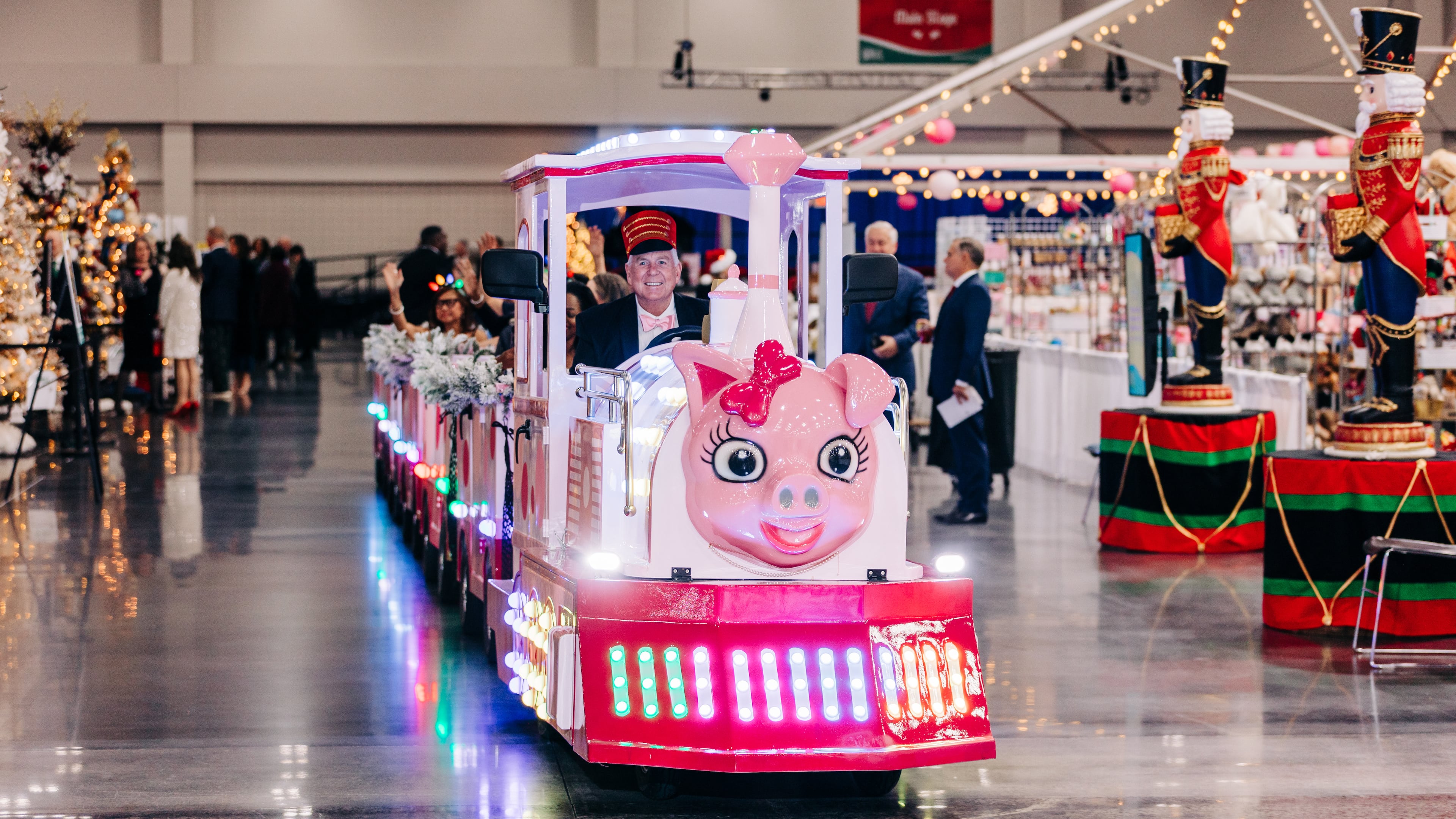 Riding the Pink Pig is a favorite Festival adventure. Georgia Festival of Trees starts Nov. 22 at the Gas South Convention Center in Duluth. Photo courtesy of Georgia Festival of Trees
