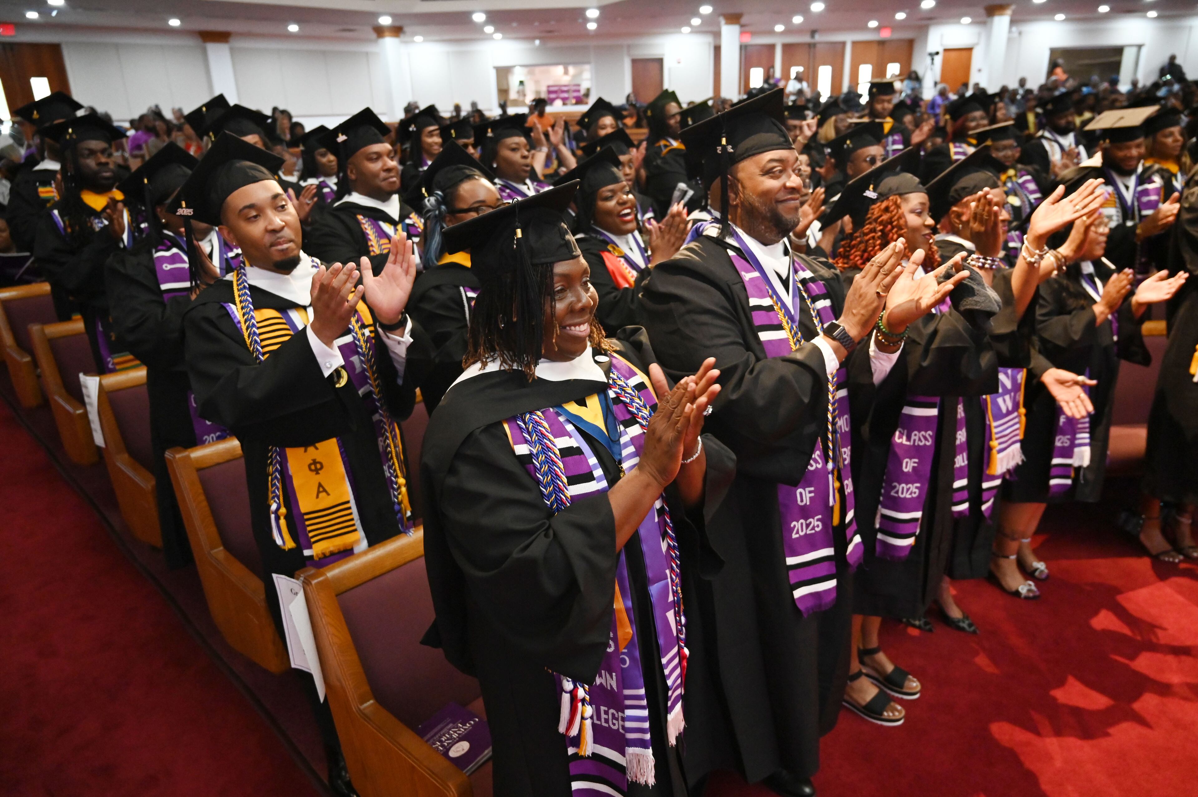 Graduates react before they receive their degrees during 2025 Morris Brown College commencement exercises at Saint Philip A.M.E. Church, Saturday, May 17, 2025, in Atlanta. (Hyosub Shin / AJC)