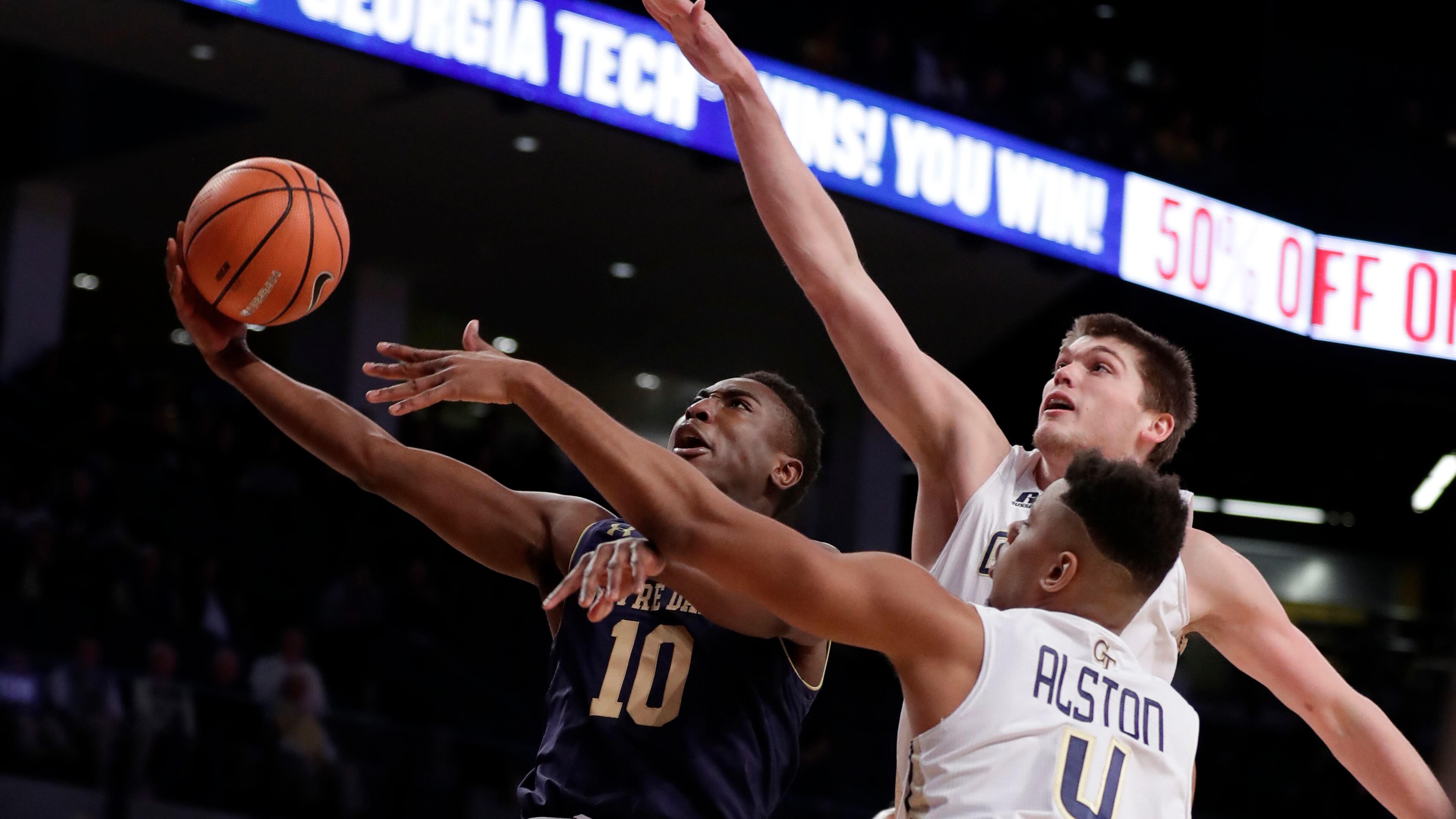 Notre Dame guard TJ Gibbs (10) is defended by Georgia Tech's Ben Lammers and Brandon Alston (4) as he drives to the basket during the first half of an NCAA college basketball game Wednesday, Jan. 10, 2018, in Atlanta. (AP Photo/John Bazemore)