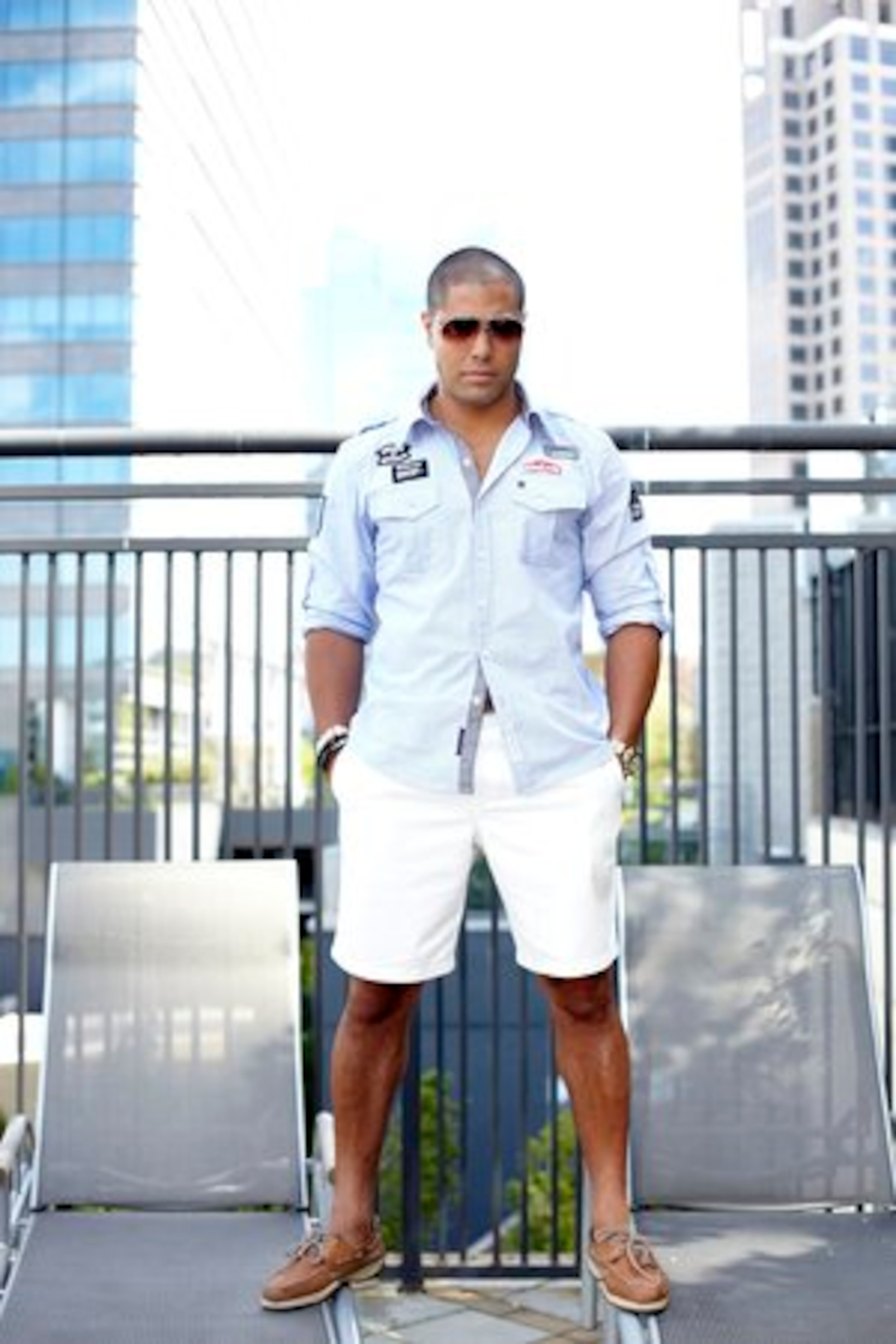 Ramos wears a casual shirt with custom patches from Moda404 in Atlanta along with his Ralph Lauren chinos. Completing the look is a pair of vintage Carerra by Porsche Design sunglasses and a pair of Sperry Top-Sider shoes.