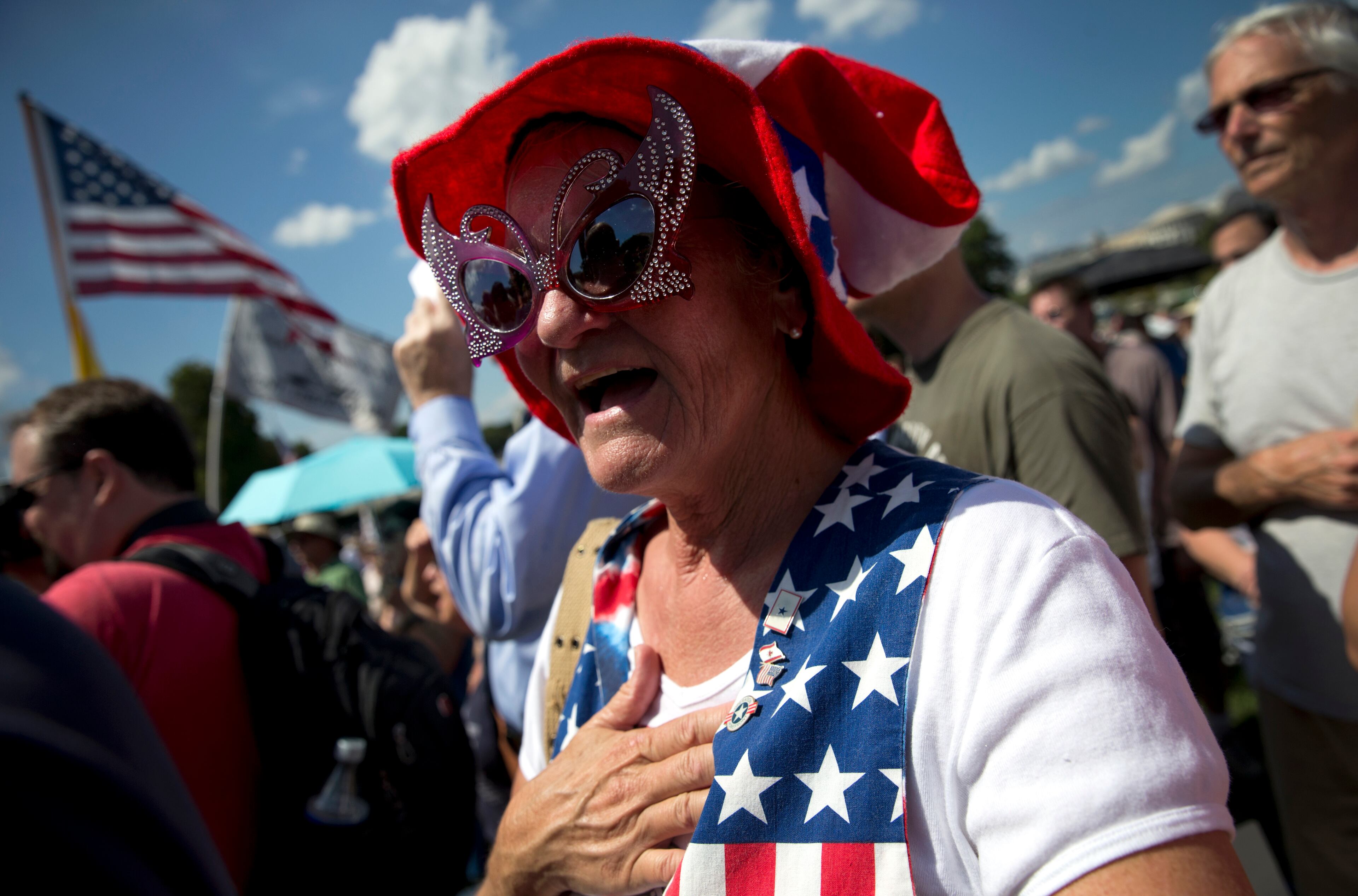 Lucy Weatherwax Chalmers of Palm Springs, Calif., places her hand over her heart during the Pledge of Allegiance at a rally organized by Tea Party Patriots in on Capitol Hill in Washington, Wednesday, Sept. 9, 2015, to oppose the Iran nuclear agreement. (AP Photo/Carolyn Kaster)
