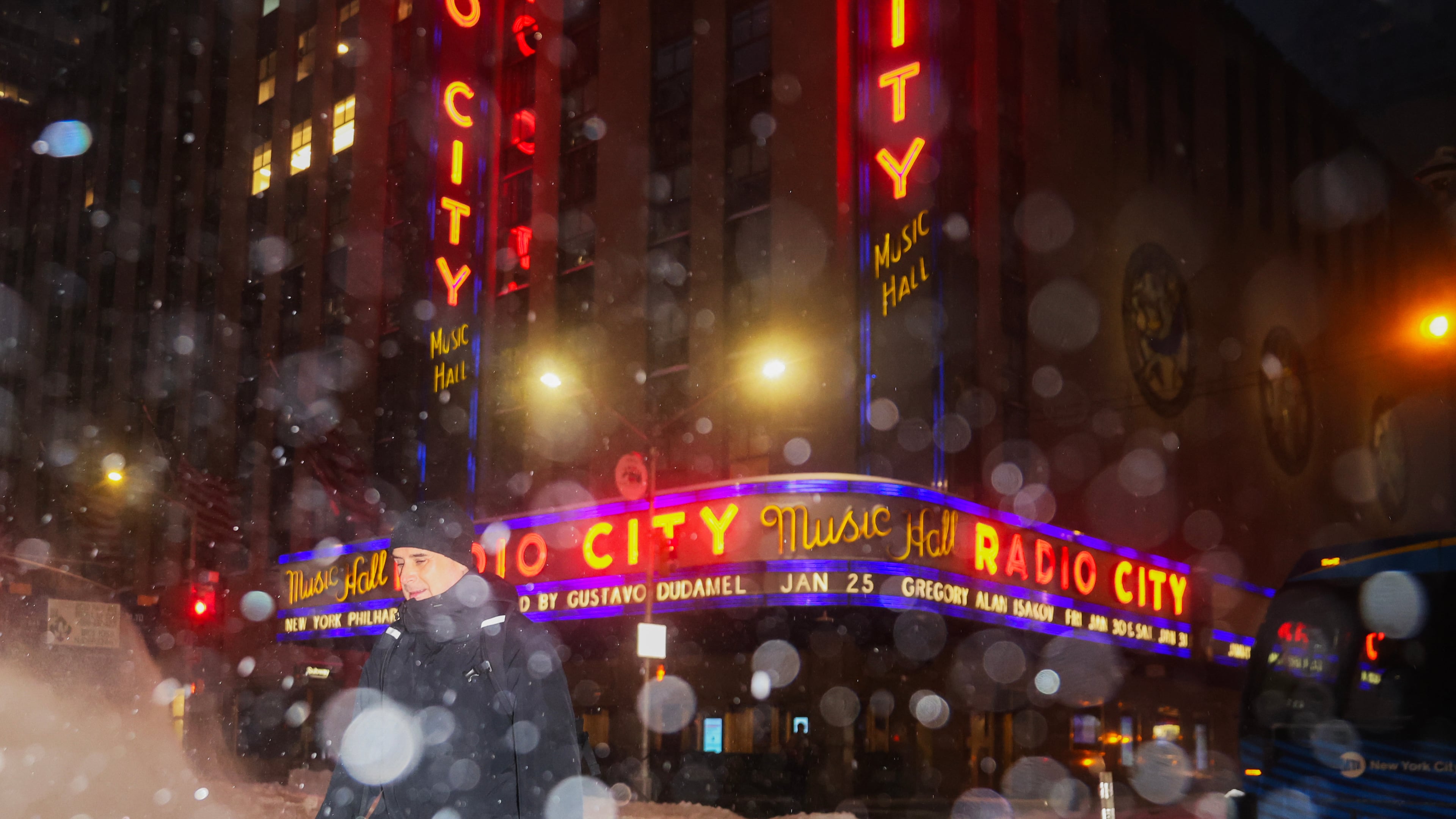 A pedestrian crosses the street near Radio City Music Hall during a winter storm, Sunday, Jan. 25, 2026, in New York. (AP Photo/Heather Khalifa)