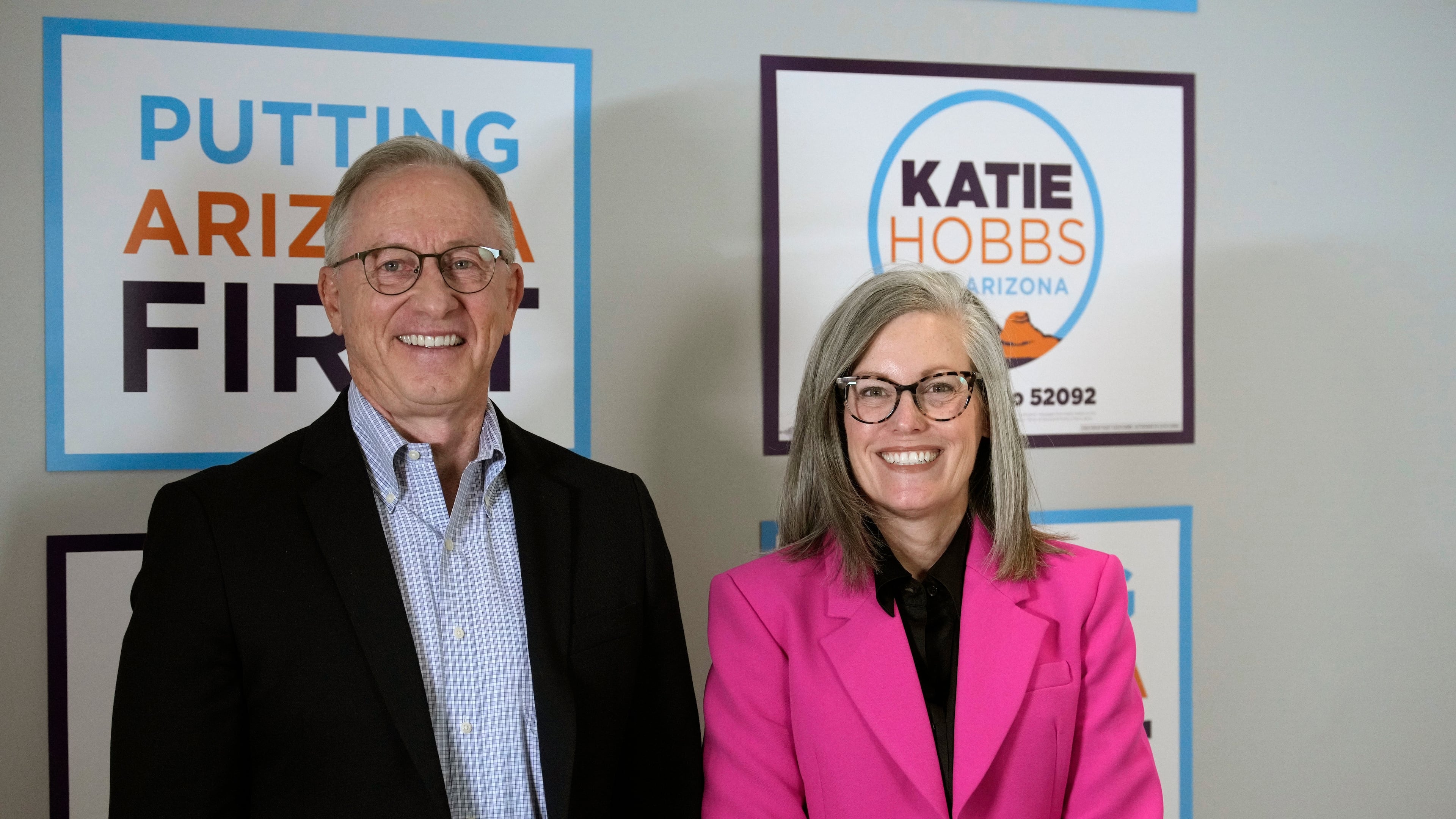Arizona Democratic Gov. Katie Hobbs, right, poses for a photograph with her running mate for Lieutenant Governor John Giles, the former Republican Mesa, Ariz., mayor, Monday, Aug. 10, 2026, in Phoenix. (AP Photo/Ross D. Franklin)