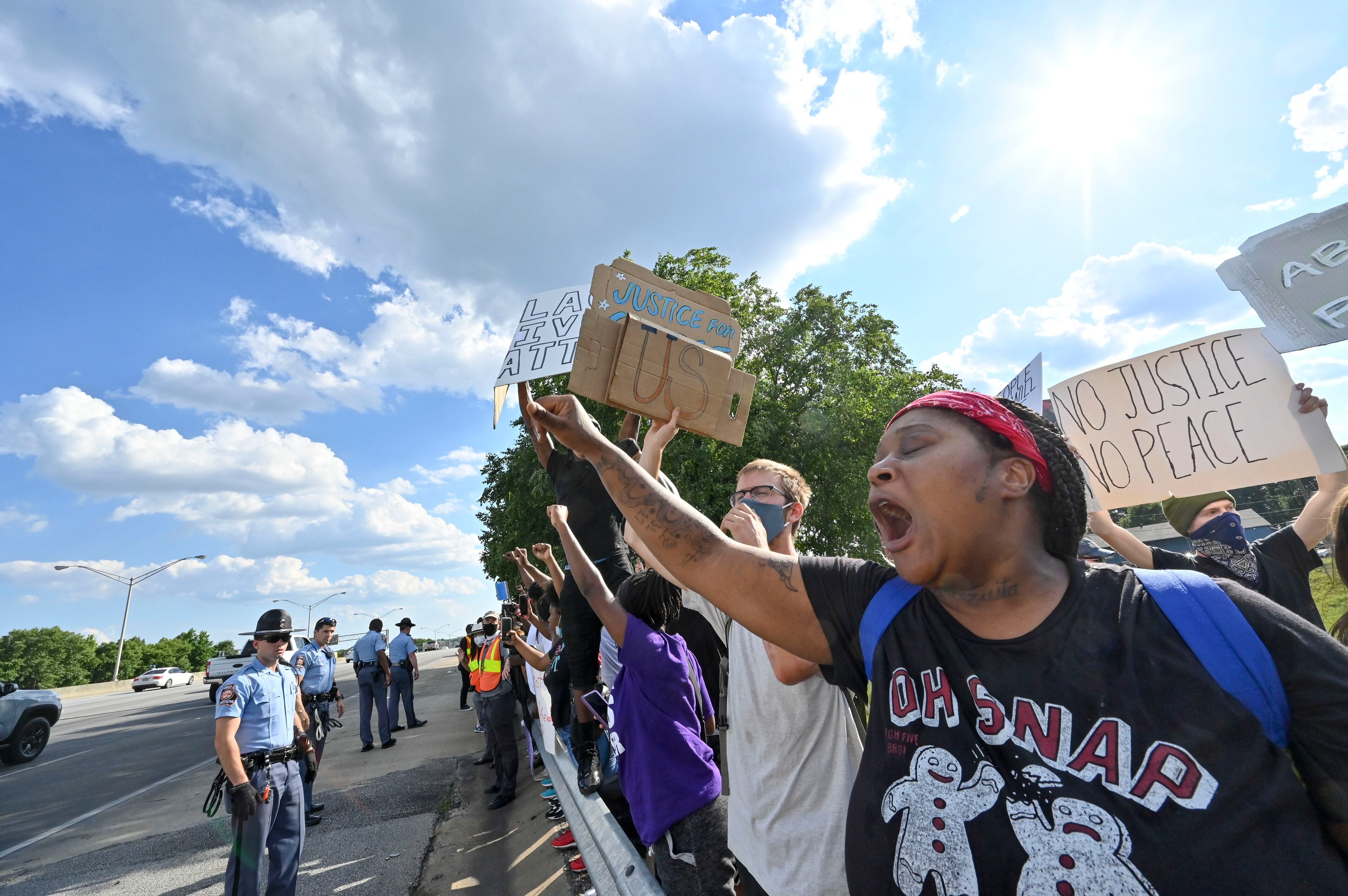 Police keep demonstrators off of the interstate as protesters gather at University Avenue, on Saturday afternoon, June 13, 2020, near the Atlanta Wendy's where Rayshard Brooks, a 27-year-old black man, was shot and killed by Atlanta police Friday evening during a struggle in a Wendy's drive-thru line. Hyosub Shin / hyosub.shin@ajc.com