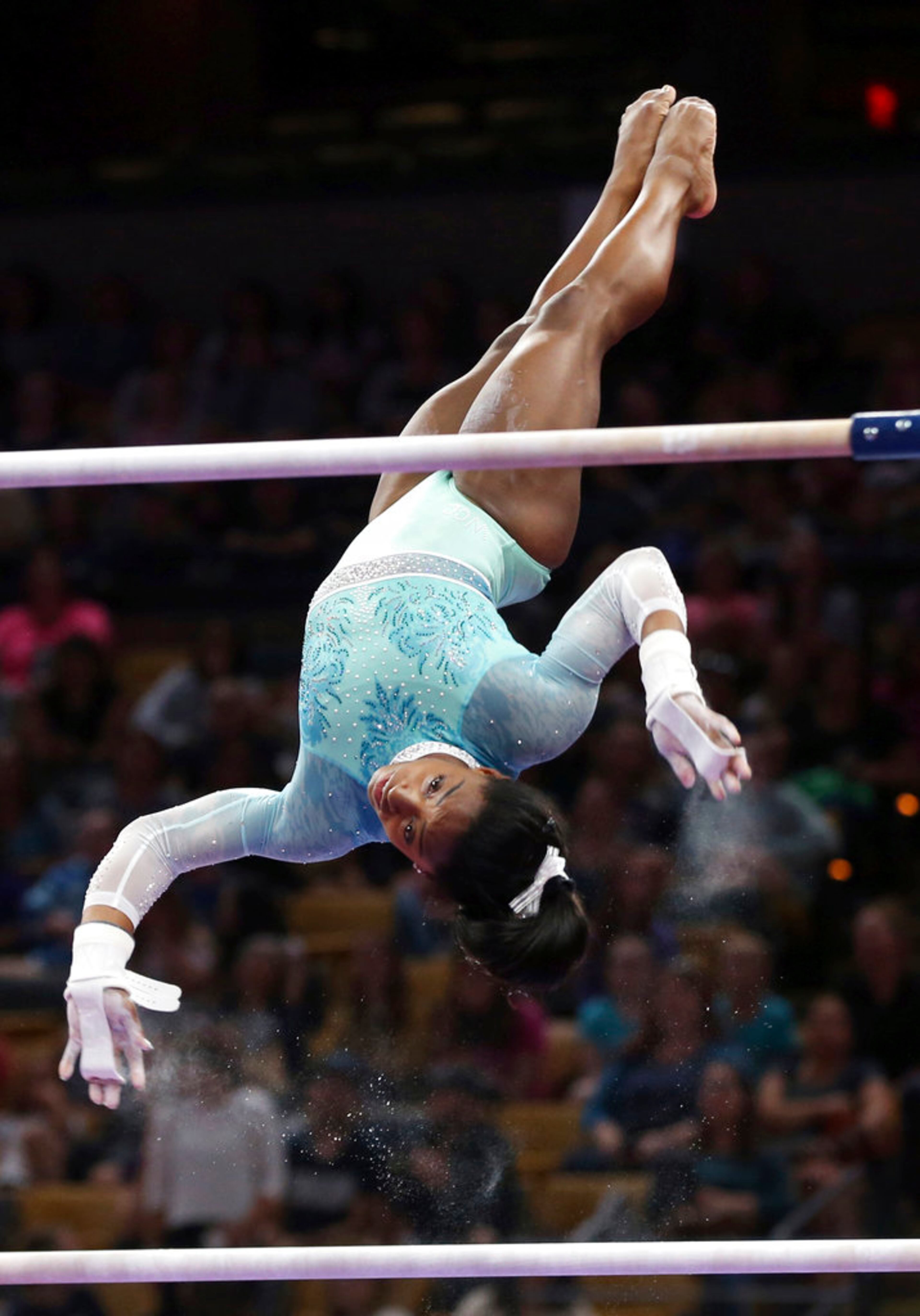 Simone Biles competes on the uneven bars at the U.S. Gymnastics Championships, Sunday, Aug. 19, 2018, in Boston. (AP Photo/Elise Amendola)
