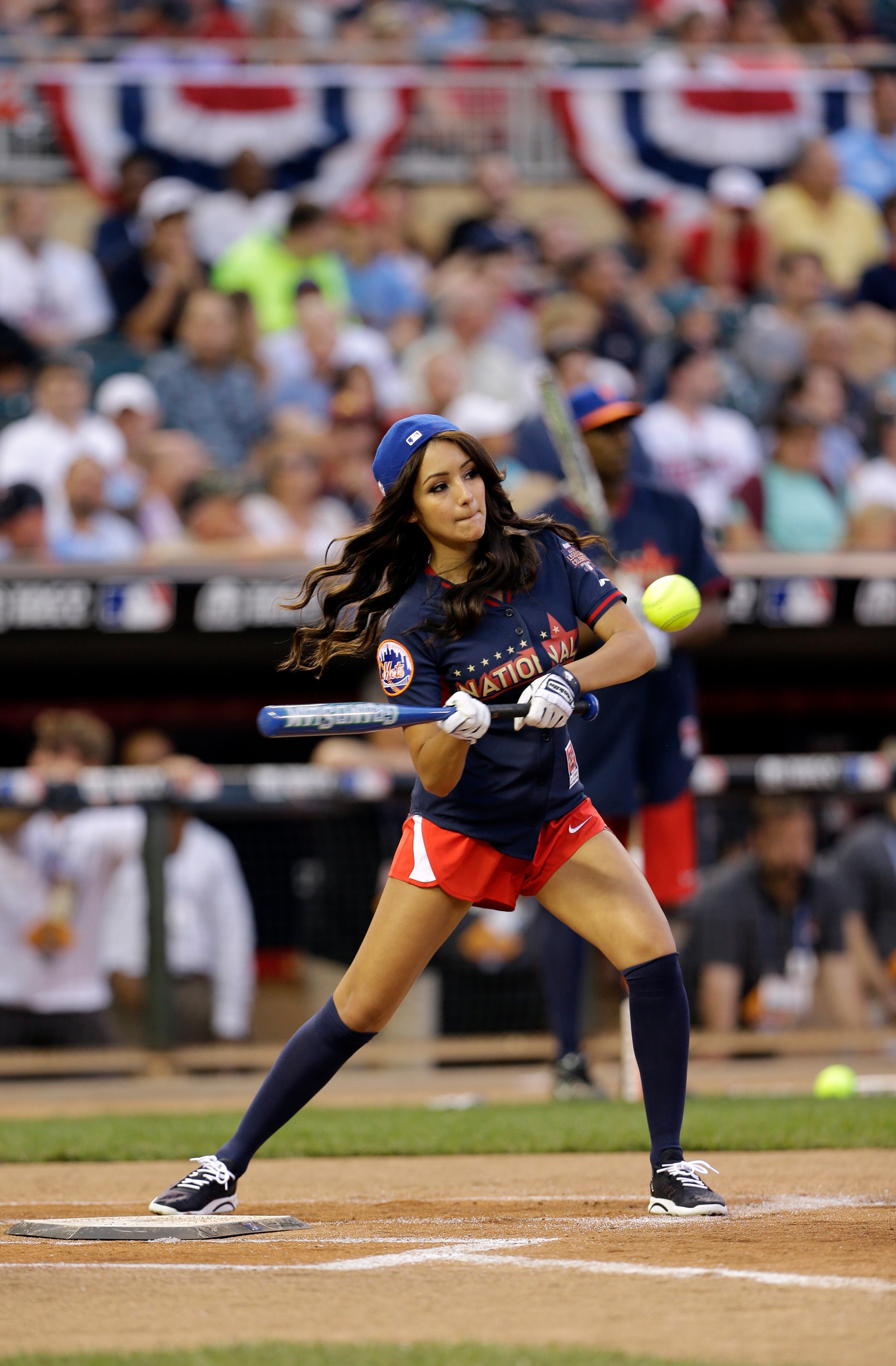 Actress Melanie Iglesias bats during the All-Star Legends & Celebrity Softball Game Sunday, July 13, 2014, in Minneapolis. (AP Photo/Paul Sancya)