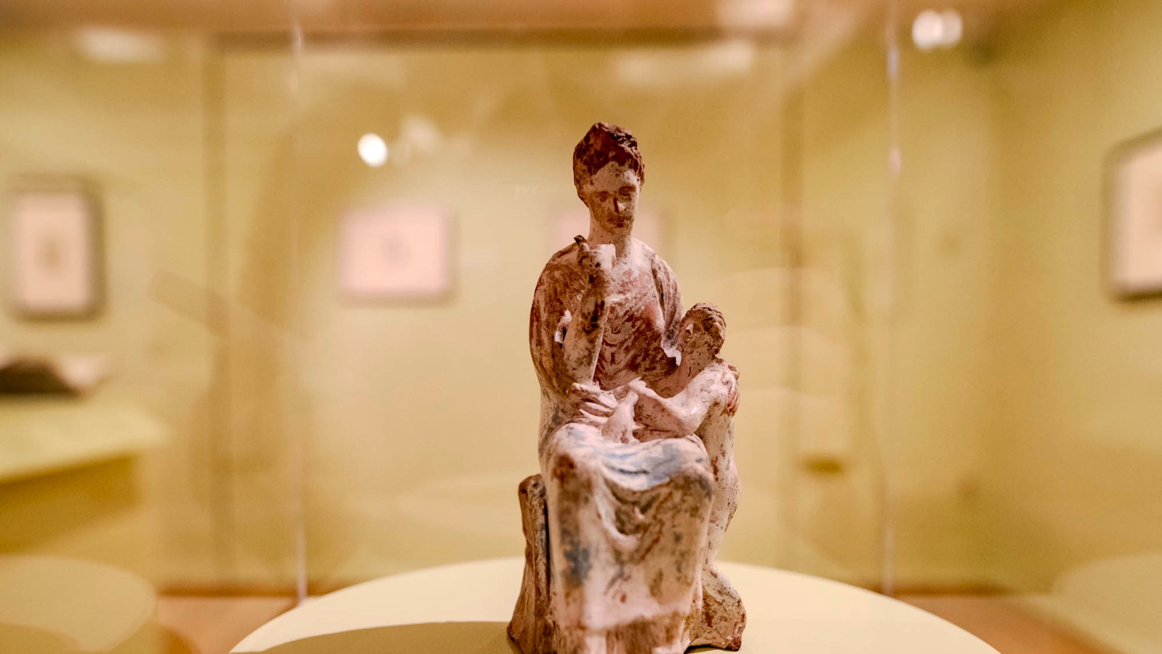 A Tanagra statuette depicting a mother and child on display at the Michael C. Carlos Museum. (Photo Courtesy of Isadora Pennington)