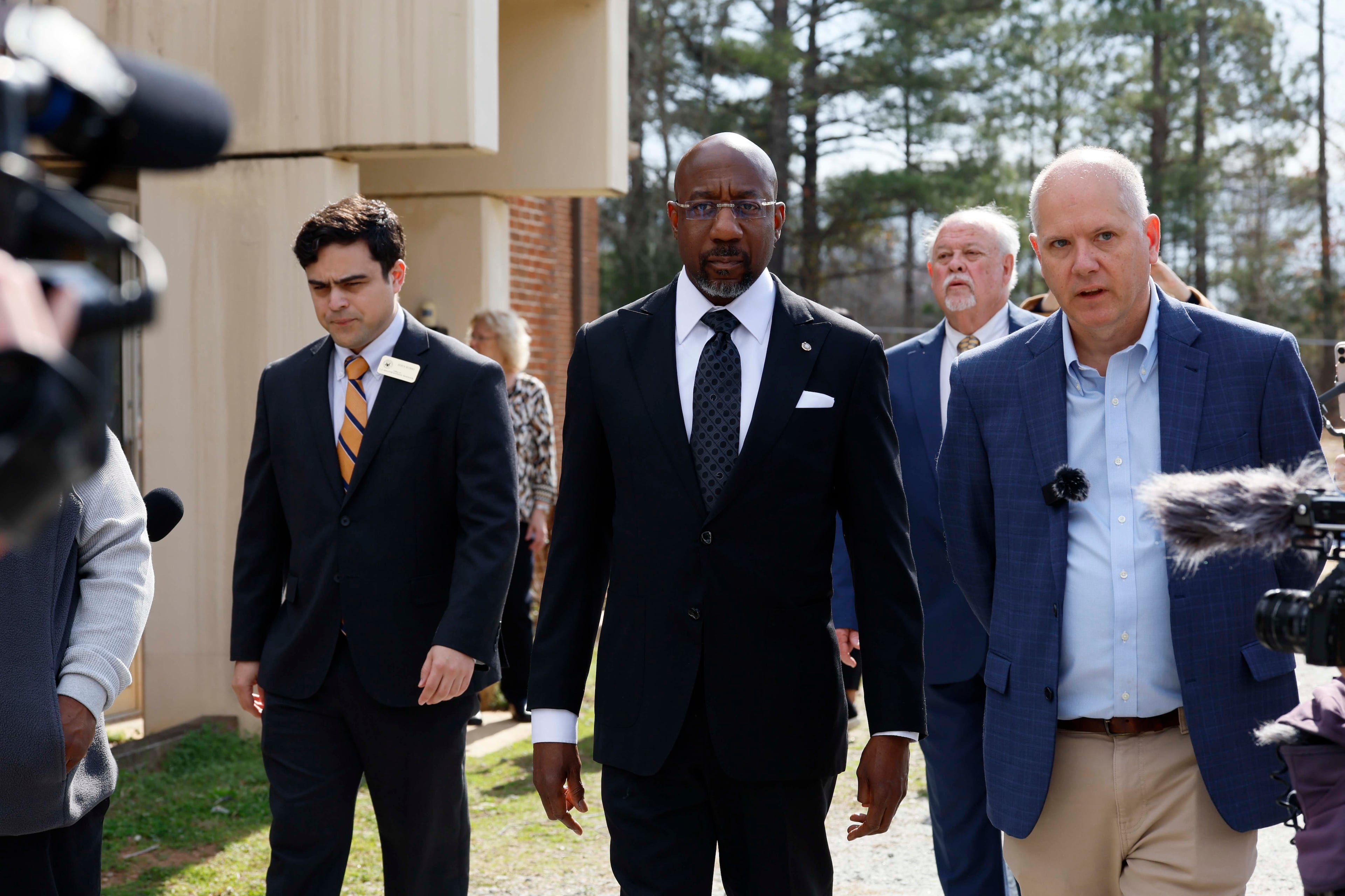 Social Circle City Manager Eric Taylor, right, walks with U.S. Senator Reverend Raphael Warnock (D-GA) as they tour the city's Drinking Water Treatment facility on Monday, March 2, 2026. Social Circle is in turmoil after the Trump Administration decided to establish a new ICE detention center, which would put additional pressure on local resources. (Miguel Martinez/AJC)