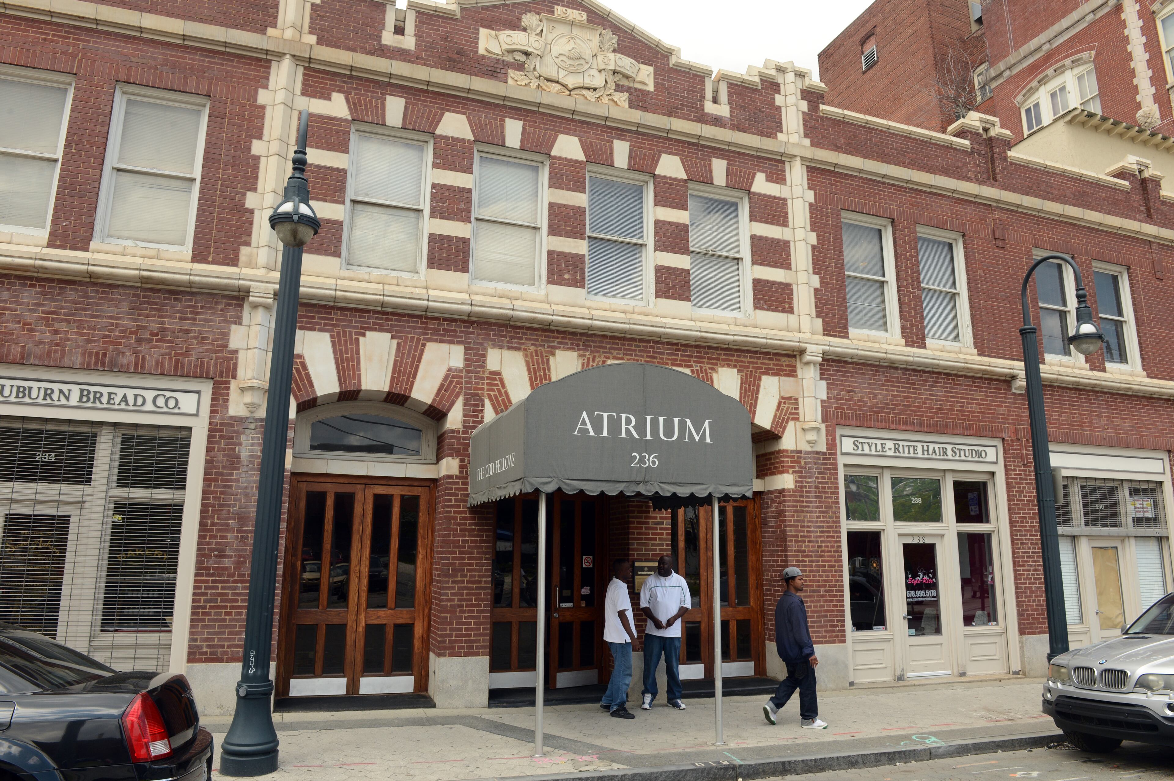 Men talk on the sidewalk outside the Odd Fellows Building in April 2013. It housed some of the city's premier black businesses and for decades stood as a testament to black self help. Photo: Kent D. Johnson, kdjohnson@ajc.com