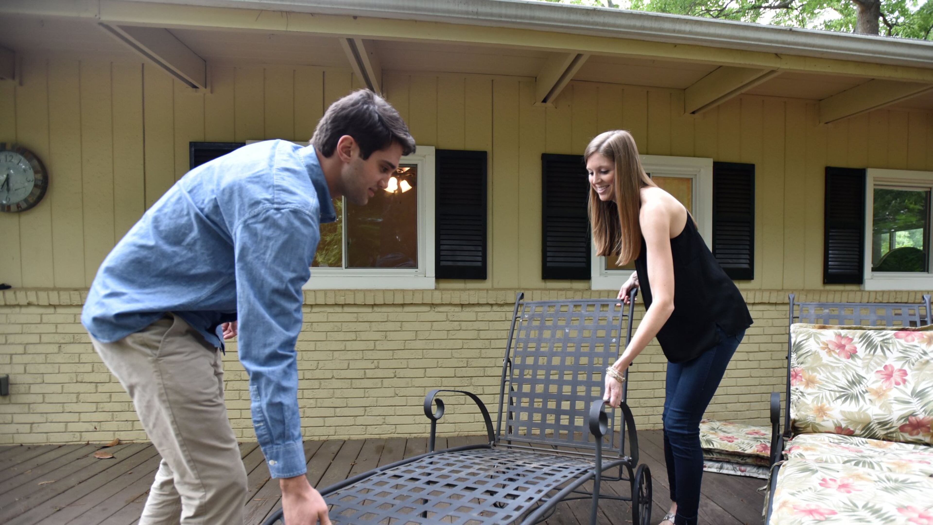 Mark Viglotti and fiance Corey English arrange outdoor furnitures at their new home in Brookhaven. HYOSUB SHIN / HSHIN@AJC.COM