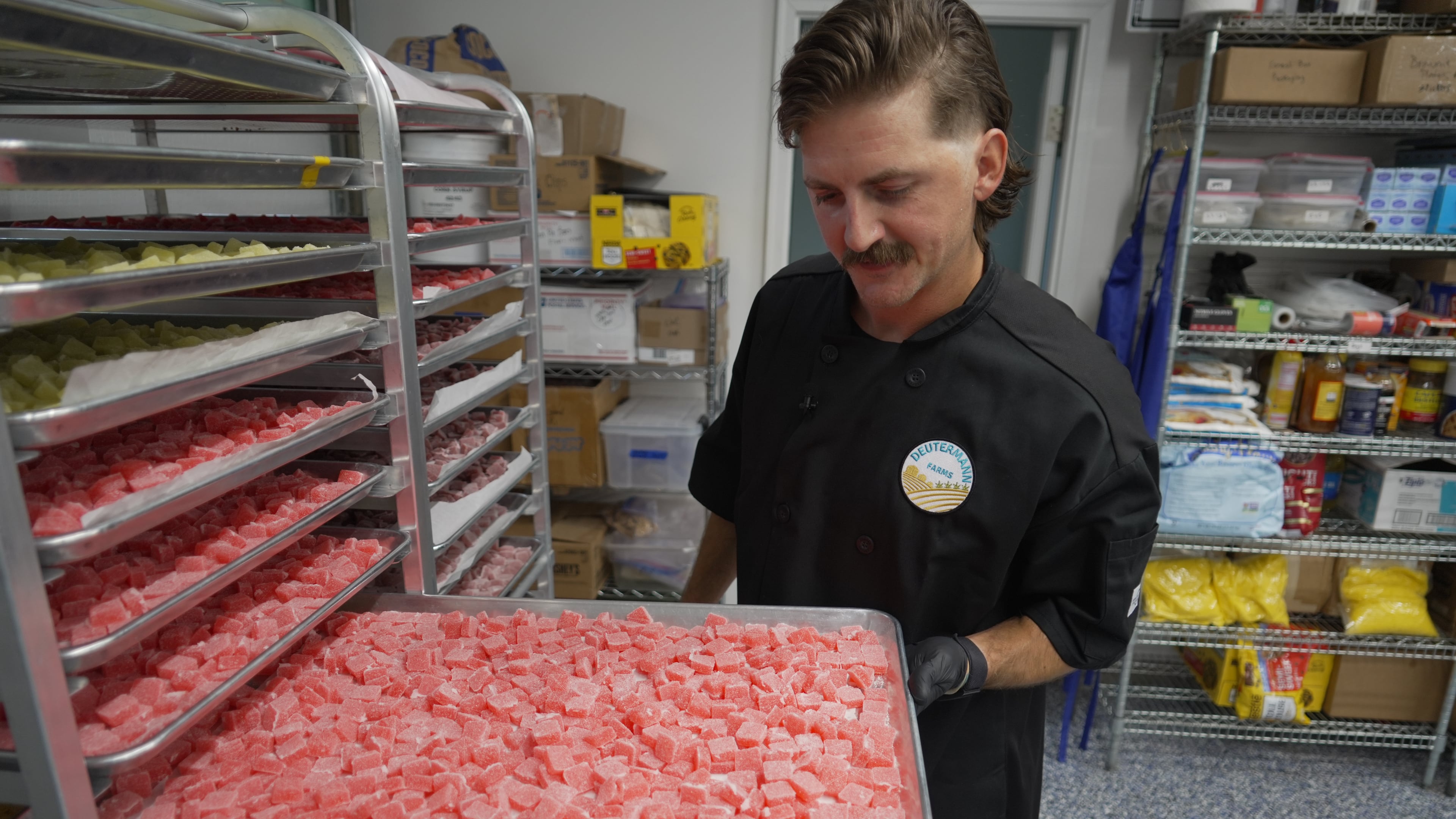 Nicholas Hohns shows off a tray of strawberry-lemon CBD gummies at his Deutermann Farms kitchen in Clayton, N.C., on Wednesday, Sept. 23, 2026. (AP Photo/Allen G. Breed)