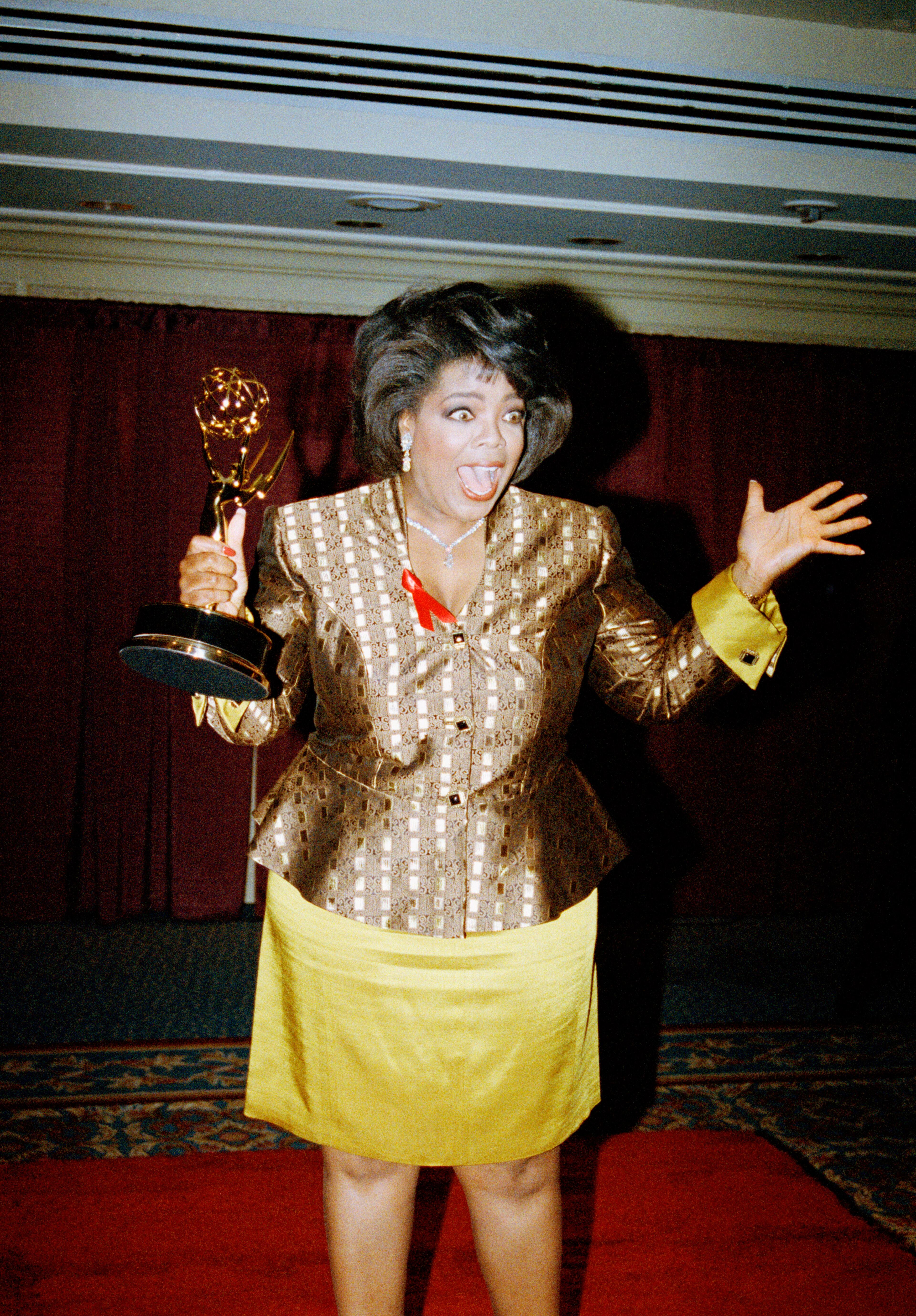 Talk show host Oprah Winfrey hams it up for the cameras after winning an Emmy for the outstanding talk/service show host during the 19th Annual Daytime Emmy Awards on Tuesday June 23, 1992 in New York. (AP Photo/Luiz Ribeiro)