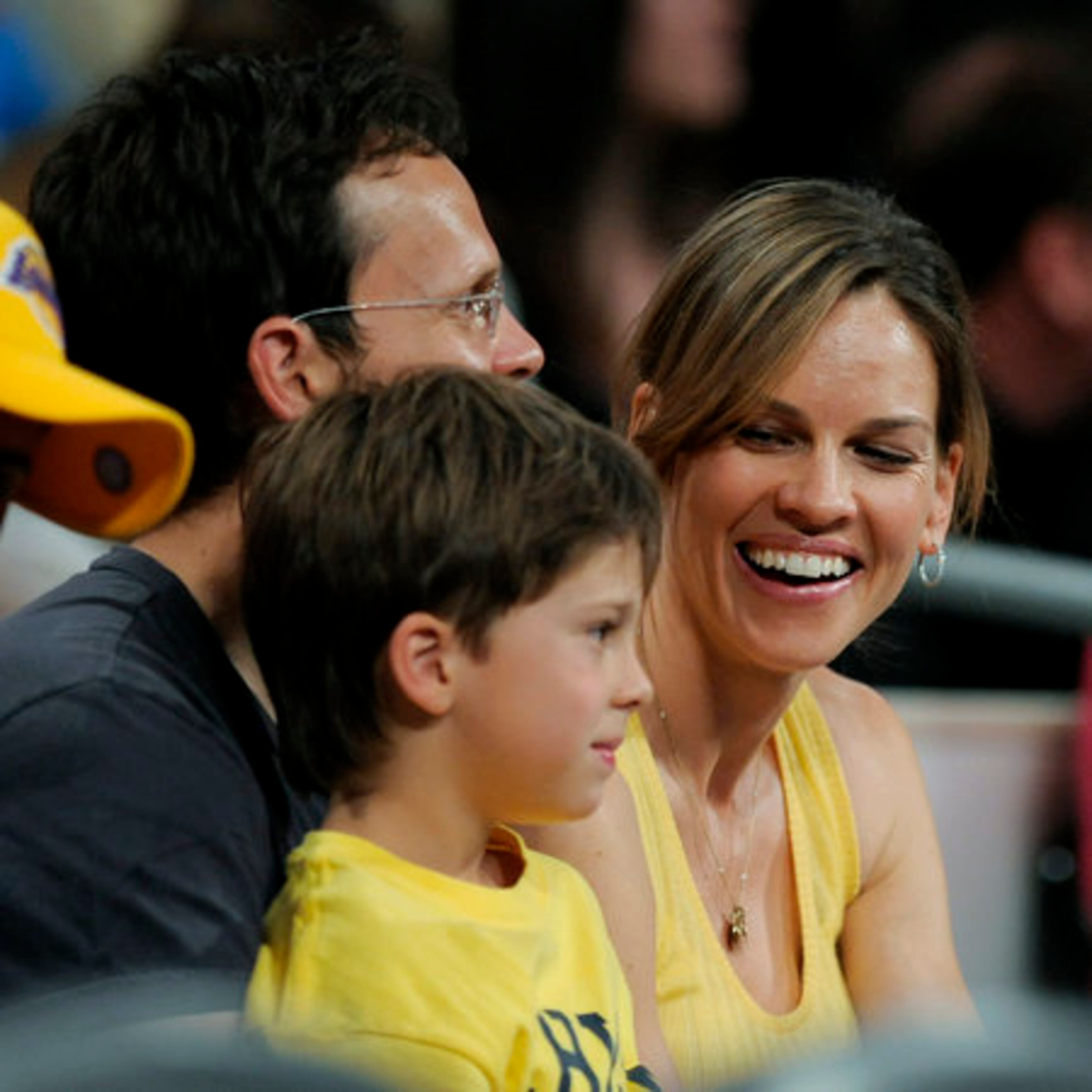 Actress Hilary Swank and her boyfriend, John Campisi, and his son Sam watch the first half of Game 2 of the NBA basketball finals between the Los Angeles Lakers and the Boston Celtics on Sunday, June 6, 2010, in Los Angeles.