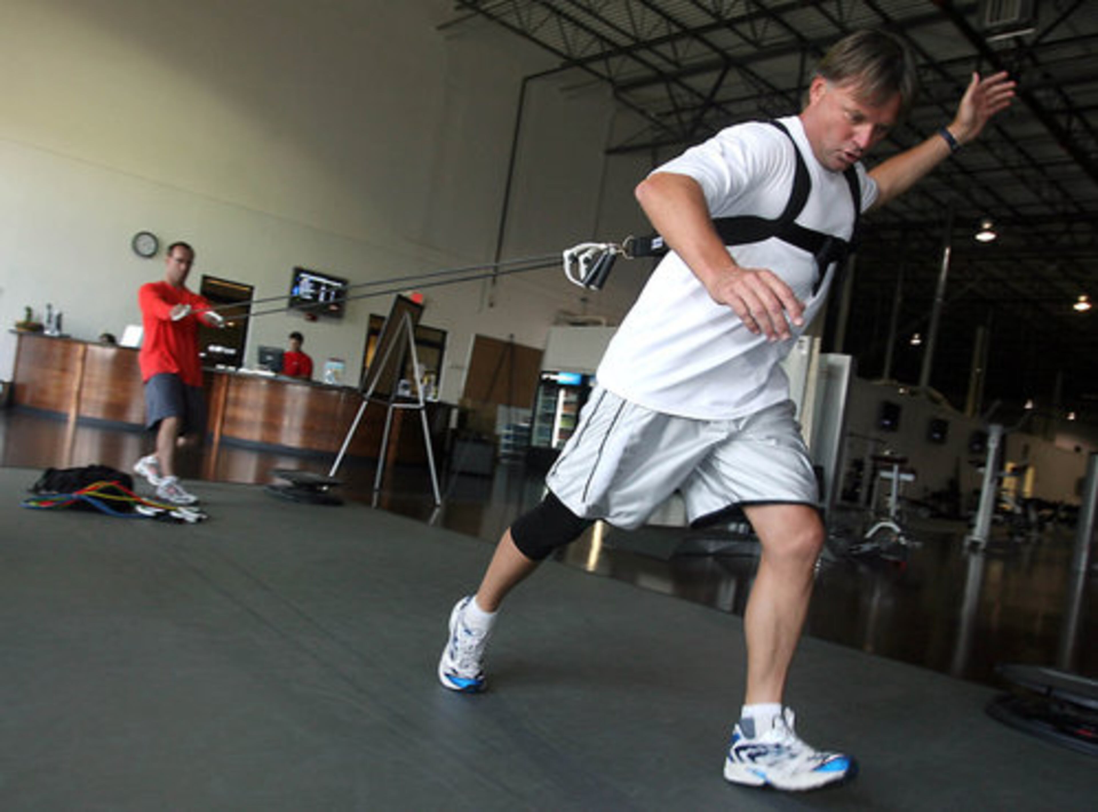 Andersen, at age 46 in this 2007 photo, shows why the veteran NFL kicker and Buford resident set so many records during his long career. Keith Elmore supervises Andersen's spring conditioning exercises with a rubber resistance band in May, 2007.