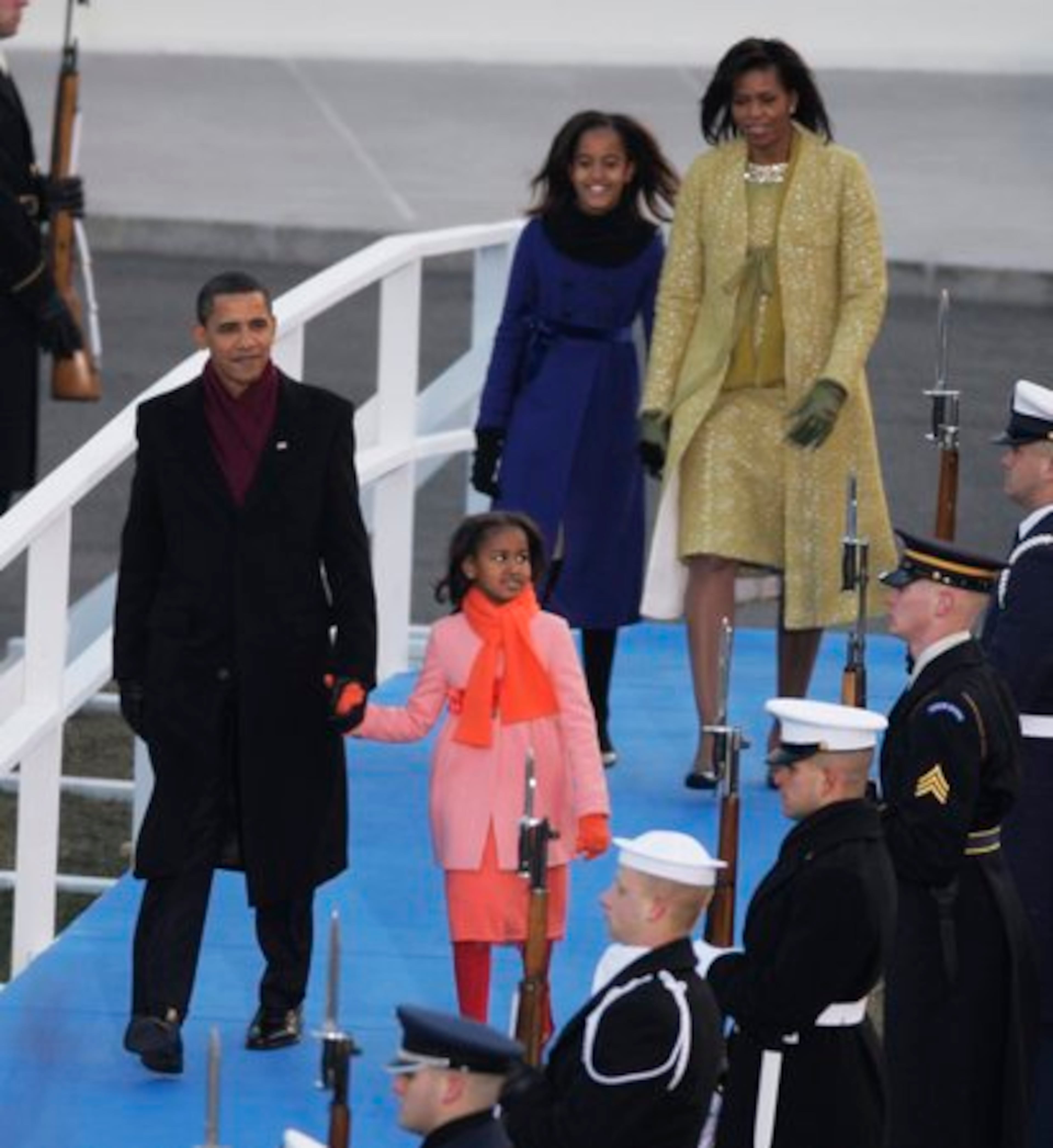 President Barack Obama, with first lady Michelle Obama and daughters Sasha and Malia walk from the White House to the reviewing stand for the inaugural parade.