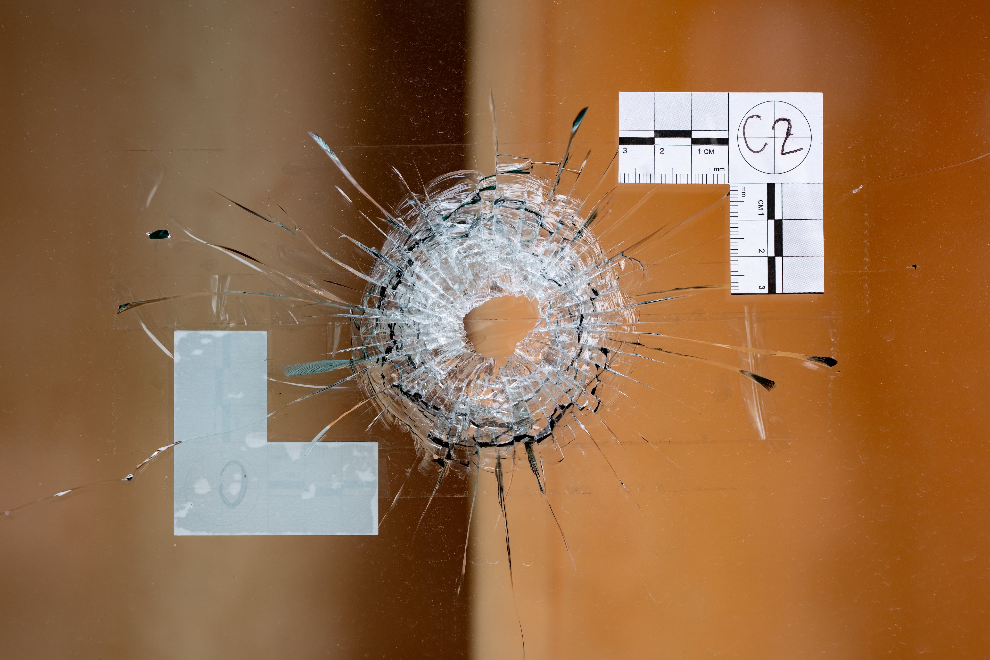 At the Budgetel Inn & Suites, just feet from Aziah McDougle’s memorial, are two windows that still — days after the shooting — have crime scene investigation markings framing bullet holes. (Ben Hendren for the AJC)