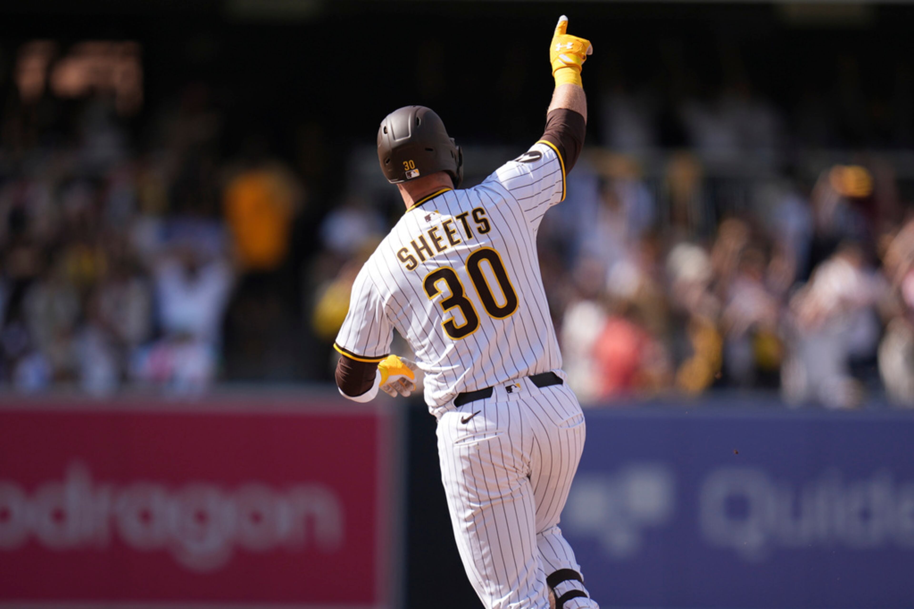 San Diego Padres' Gavin Sheets celebrates his home run during the seventh inning of an opening-day baseball game against the Atlanta Braves, Thursday, March 27, 2025, in San Diego. (AP Photo/Gregory Bull)