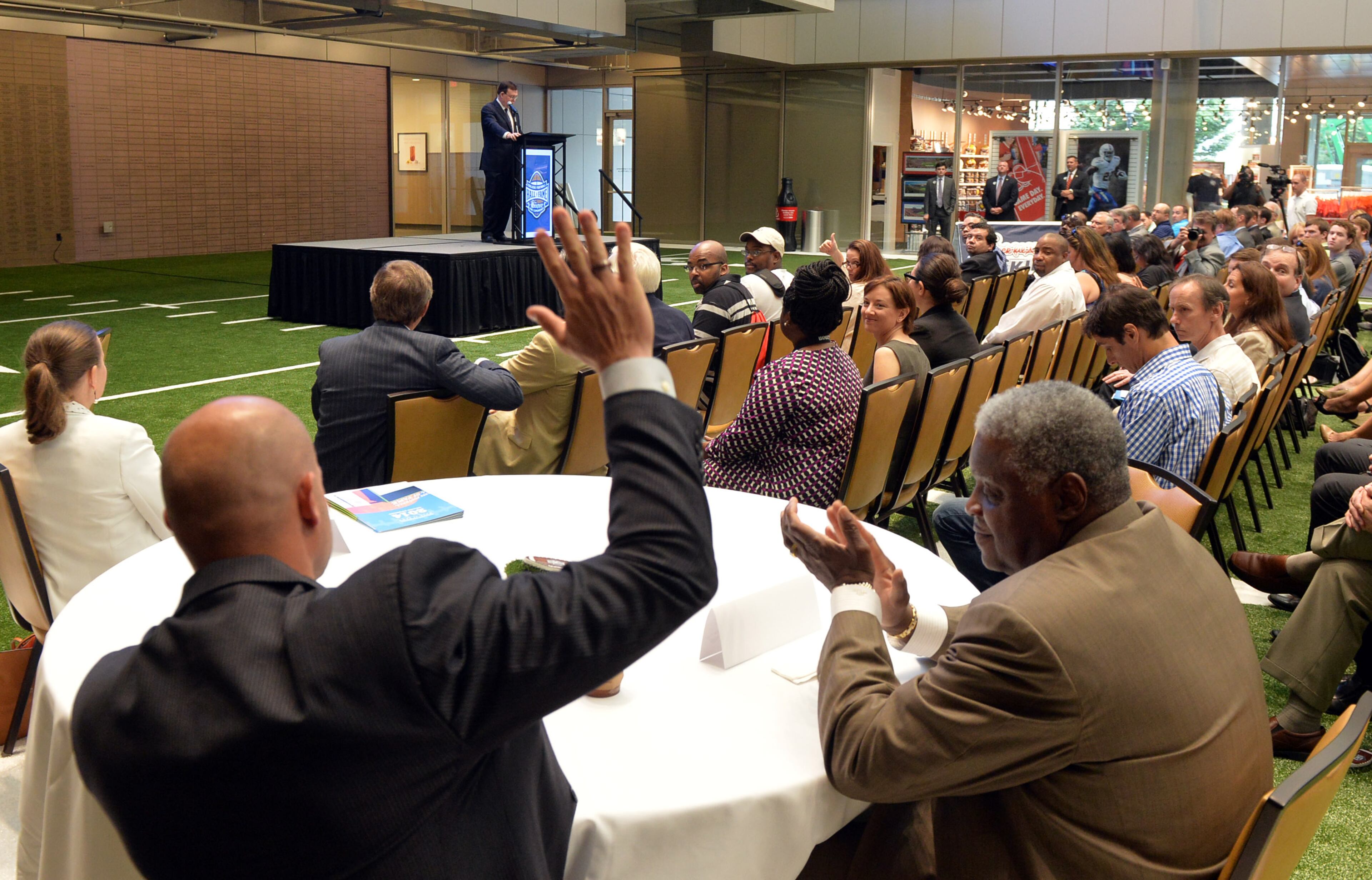 Hall of Fame quarterback Danny Wuerffel is applauded by fellow Hall member Art Shell at a press conference and media day at the College Football Hall of Fame on Wednesday, August 20, 2014.