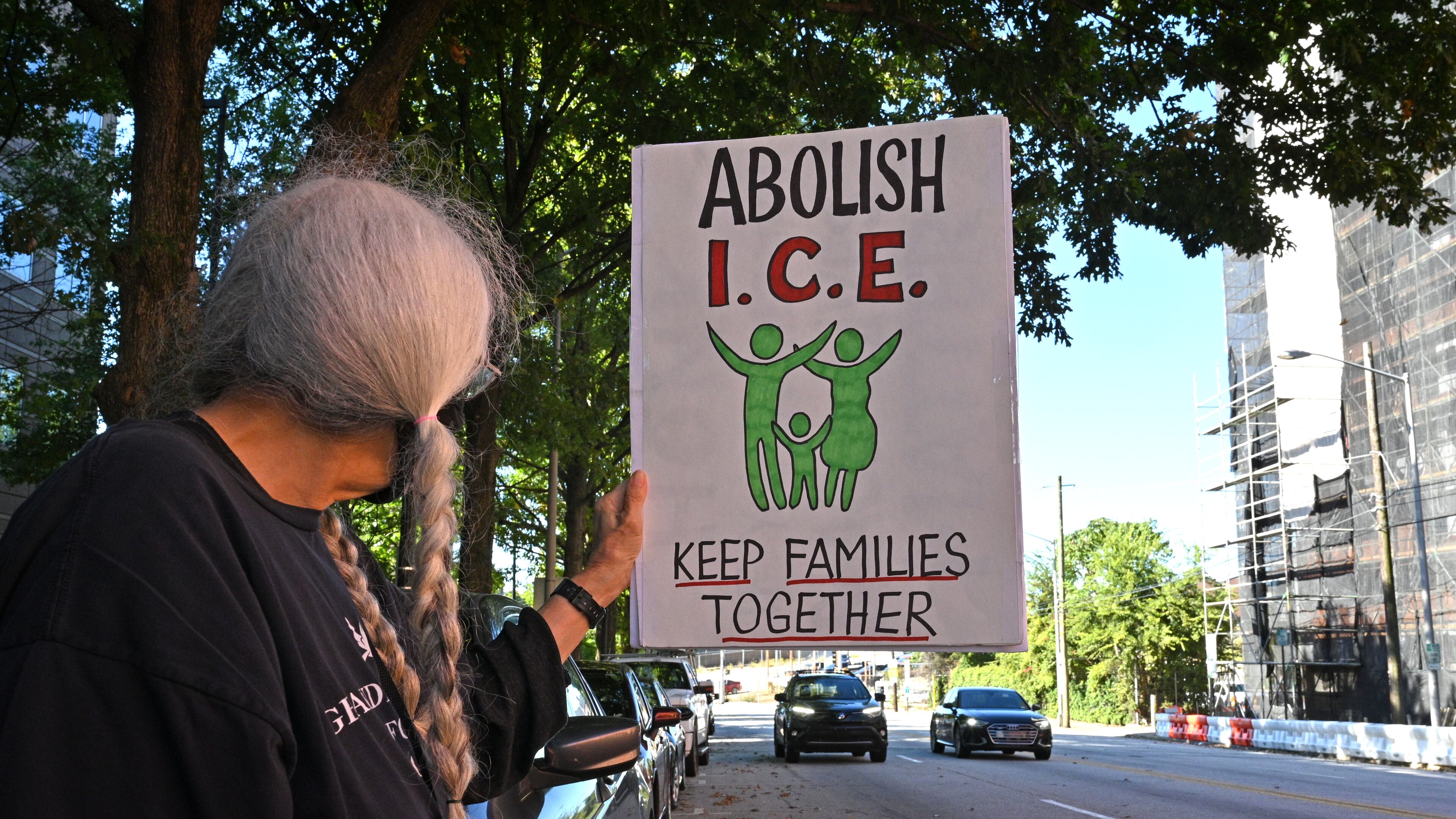 September 23, 2021 Atlanta - A protester holds a sign during a rally to demand Biden shut down detention centers, free them all and stop deportation outside ICE Atlanta Field Office on Thursday, September 23, 2021. (Hyosub Shin / Hyosub.Shin@ajc.com)