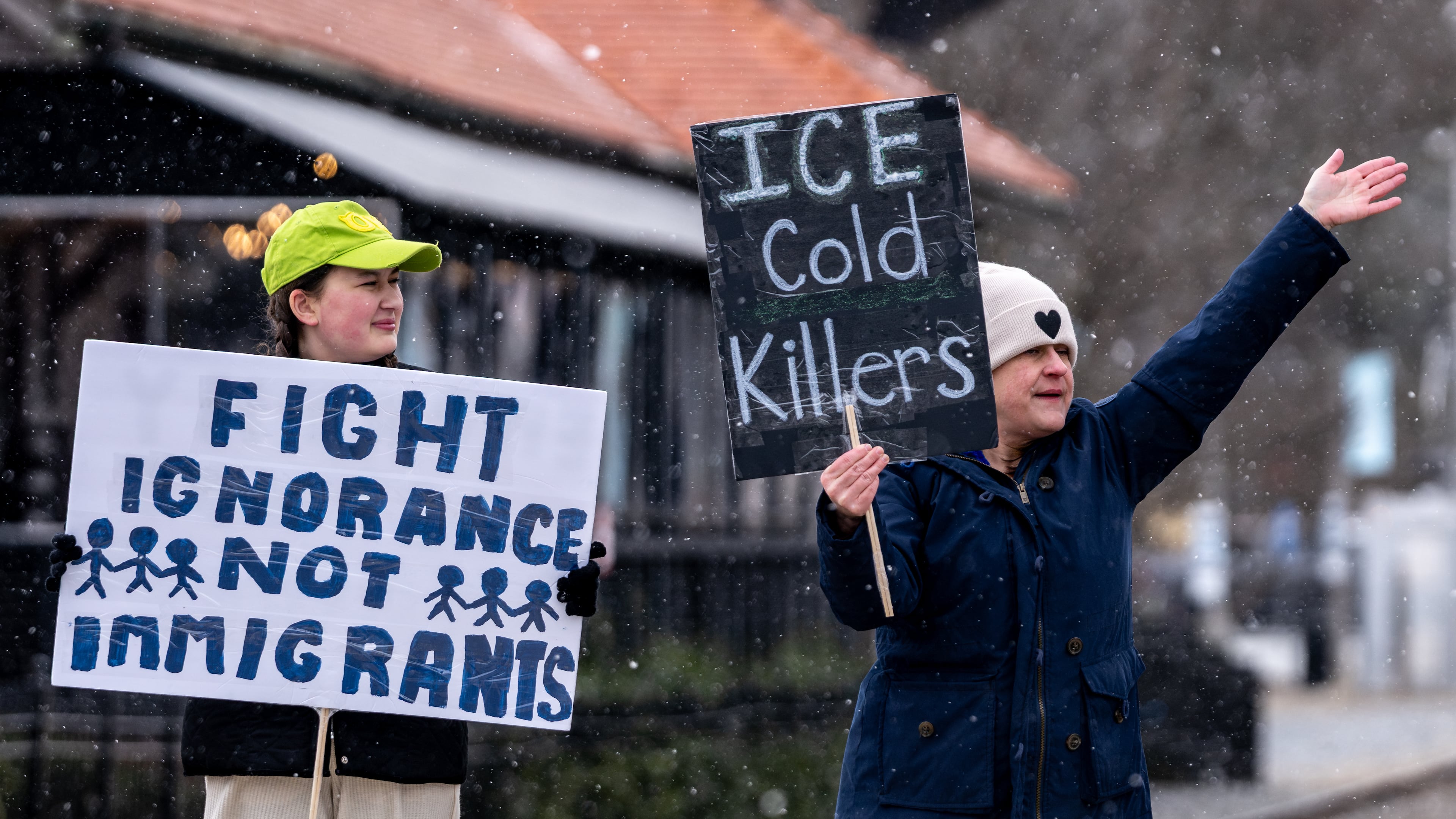 Caroline Campbell (left) and Erin Campbell protest Immigration and Customs Enforcement in Woodstock in January. (Ben Hendren for the AJC 2026)