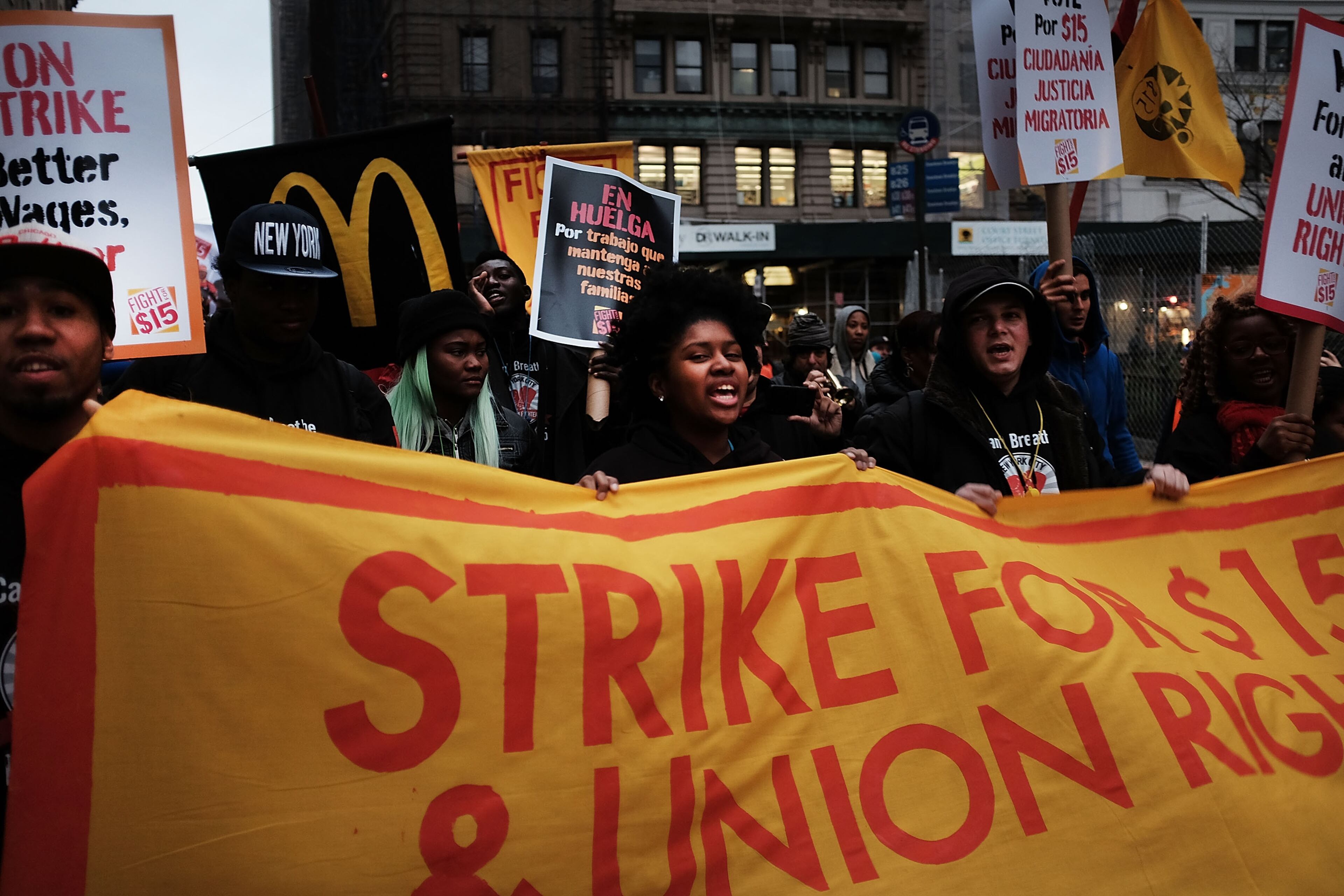 NEW YORK, NY - NOVEMBER 10: Low wage workers and supporters protest for a $15 an hour minimum wage on November 10, 2015 in New York, United States. In what organizers are calling a National Day of Action for $15 and hour minimum wage, thousands of people took to the streets across the country to stage protests in front of businesses that are paying some of their workers the minimum wage. Home care workers, employees in retail and fast food restaurants say that the current minimum is not a living wage. (Photo by Spencer Platt/Getty Images)