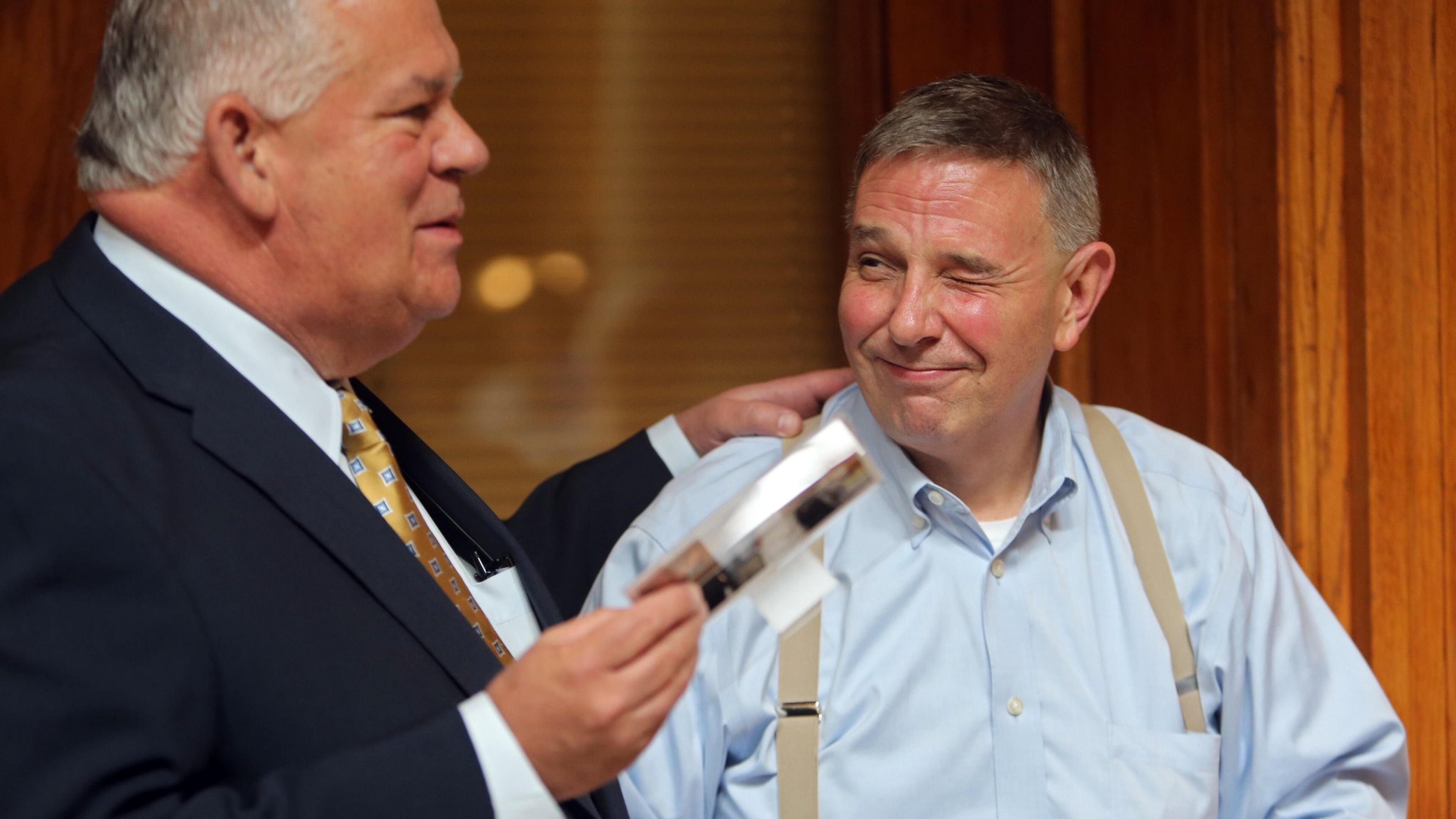LEDE PHOTO: July 24, 2013 Atlanta: Robby Rivers, right, clerk of the Georgia House of Representatives since 1991, winks at House Speaker David Ralston during a Wednesday afternoon July 24, 2013 retirement party at the State Capitol as Ralston tells a story about Rivers climbing over the Speaker’s desk at the close of the 2013 Legislative session. Rivers has been an institution at the Capitol for 27 years, the first six of which were spent as attorney for former House Speaker Tom Murphy. BEN GRAY / BGRAY@AJC.COM