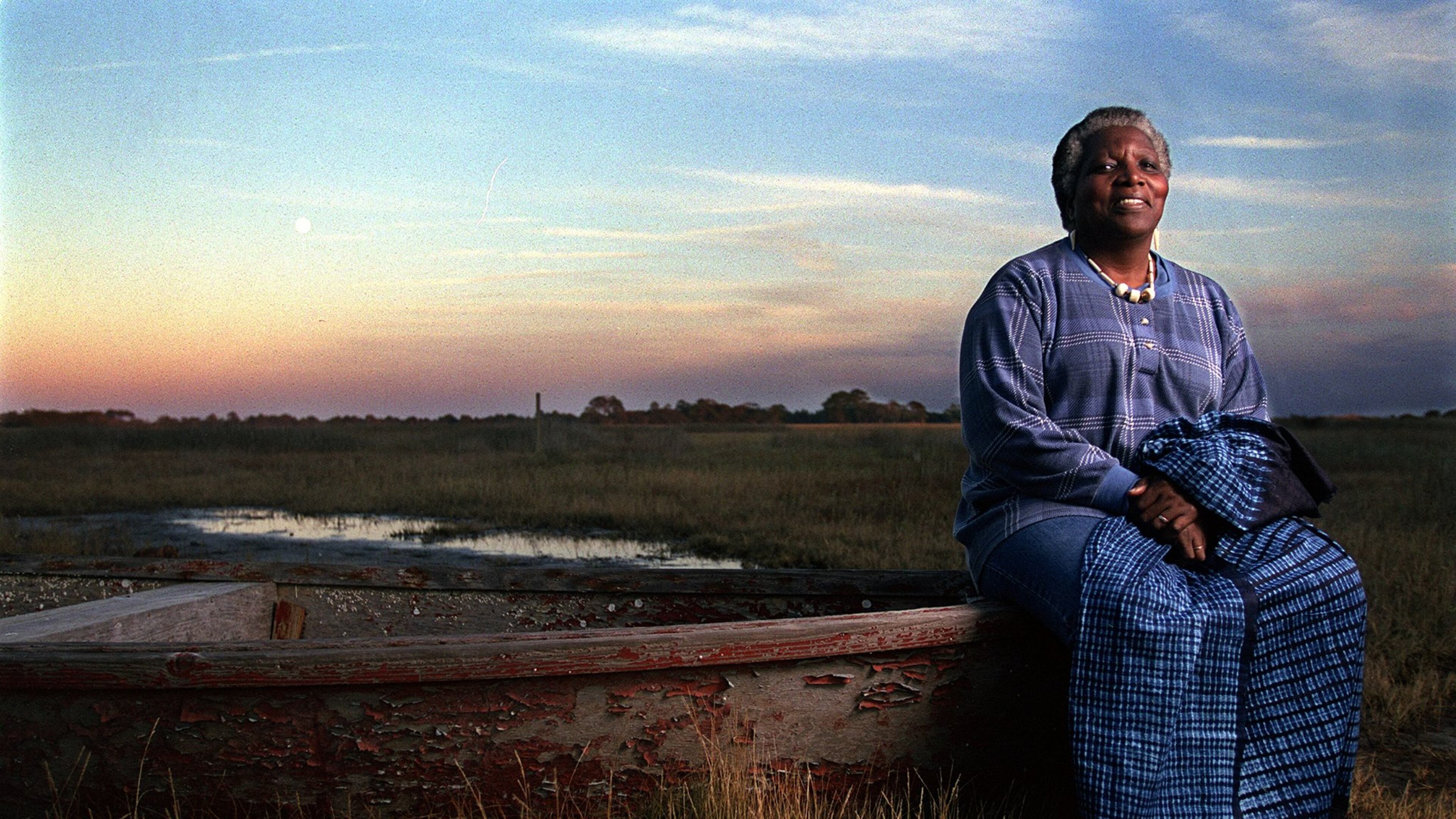 Cornelia Walker Bailey (cq) sits on a bateau on the edge of a Sapelo Island salt marsh. This bateau is one of the two traditional hand-made Geechee boats that still survives on the island. (BEN GRAY/STAFF)