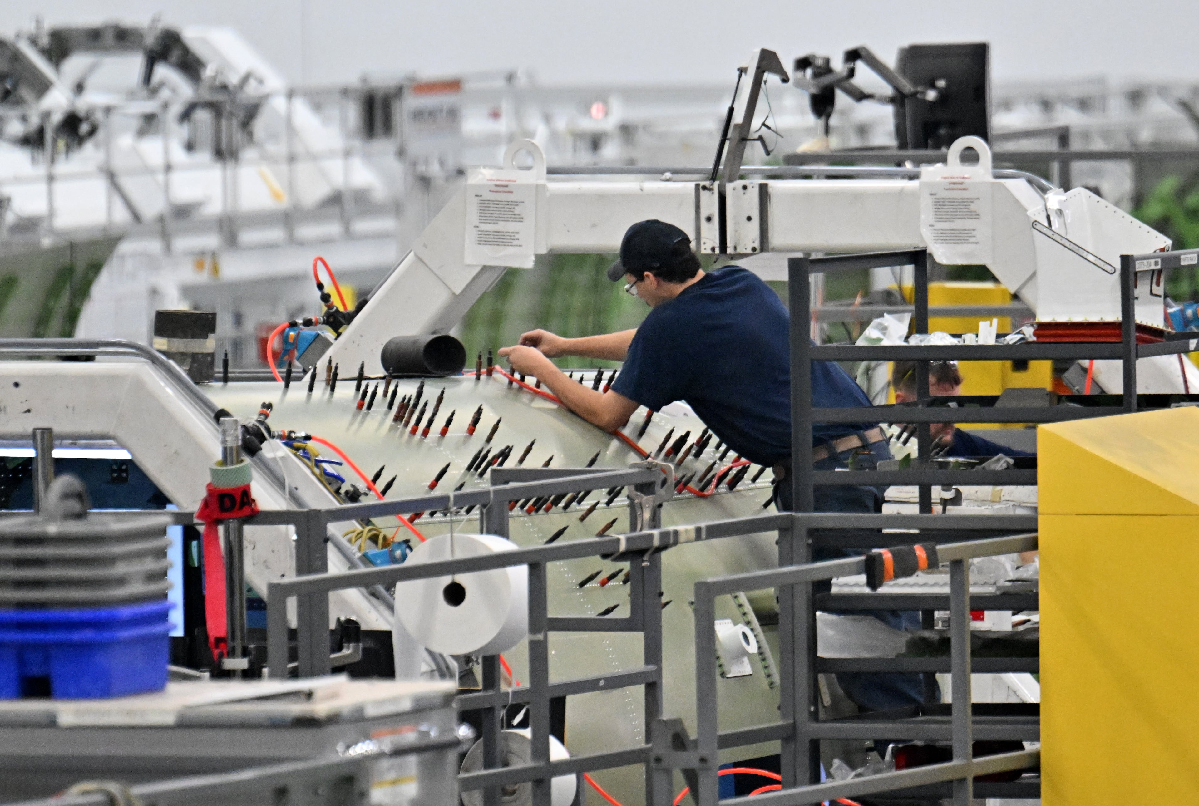 A worker works on Gulfstream’s product lines of G500 and G600 aircrafts at Gulfstream Aerospace Corporation in December. (Hyosub Shin/AJC)