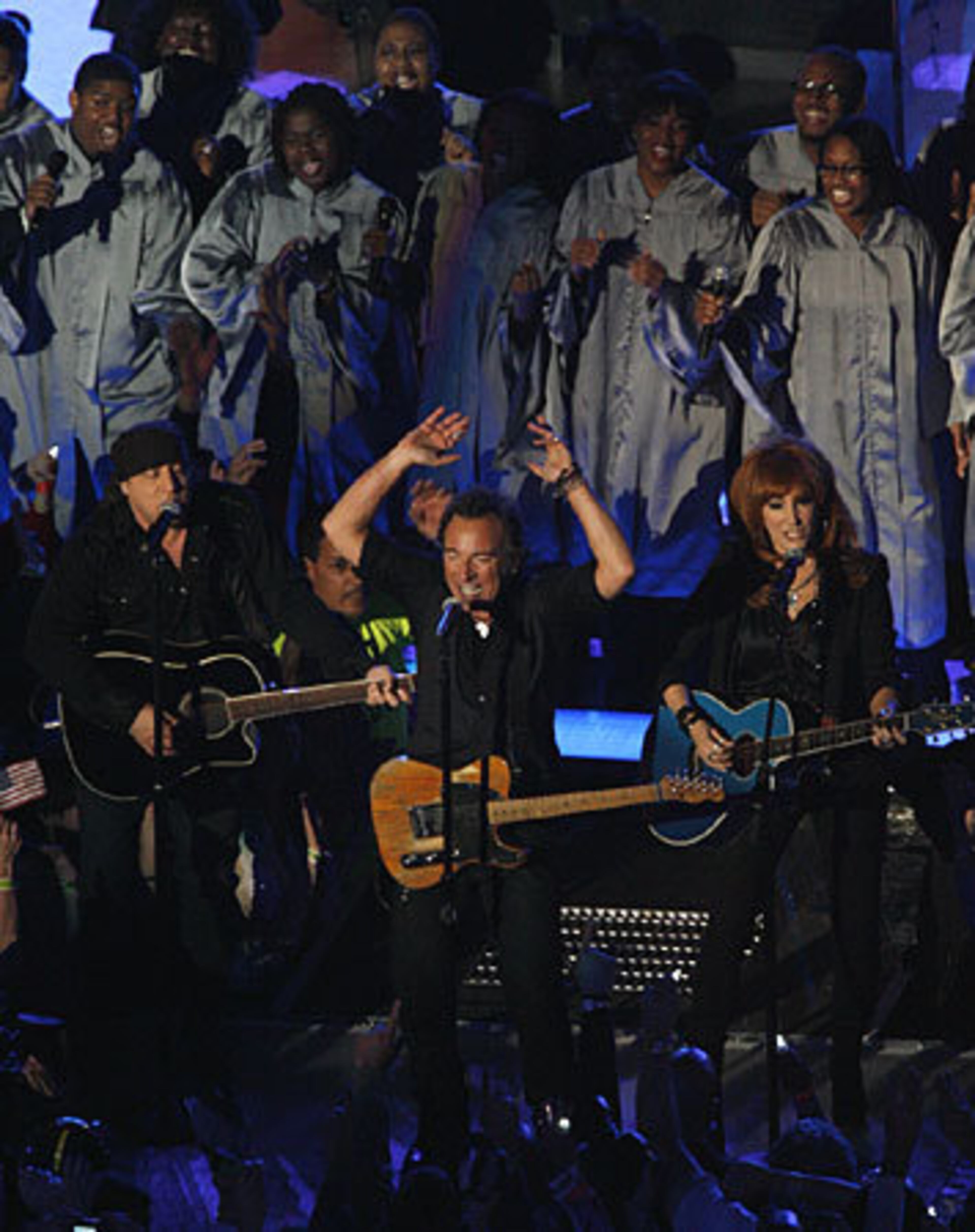 Bruce Springsteen, flanked by Steven Van Zandt and Patti Scialfa.