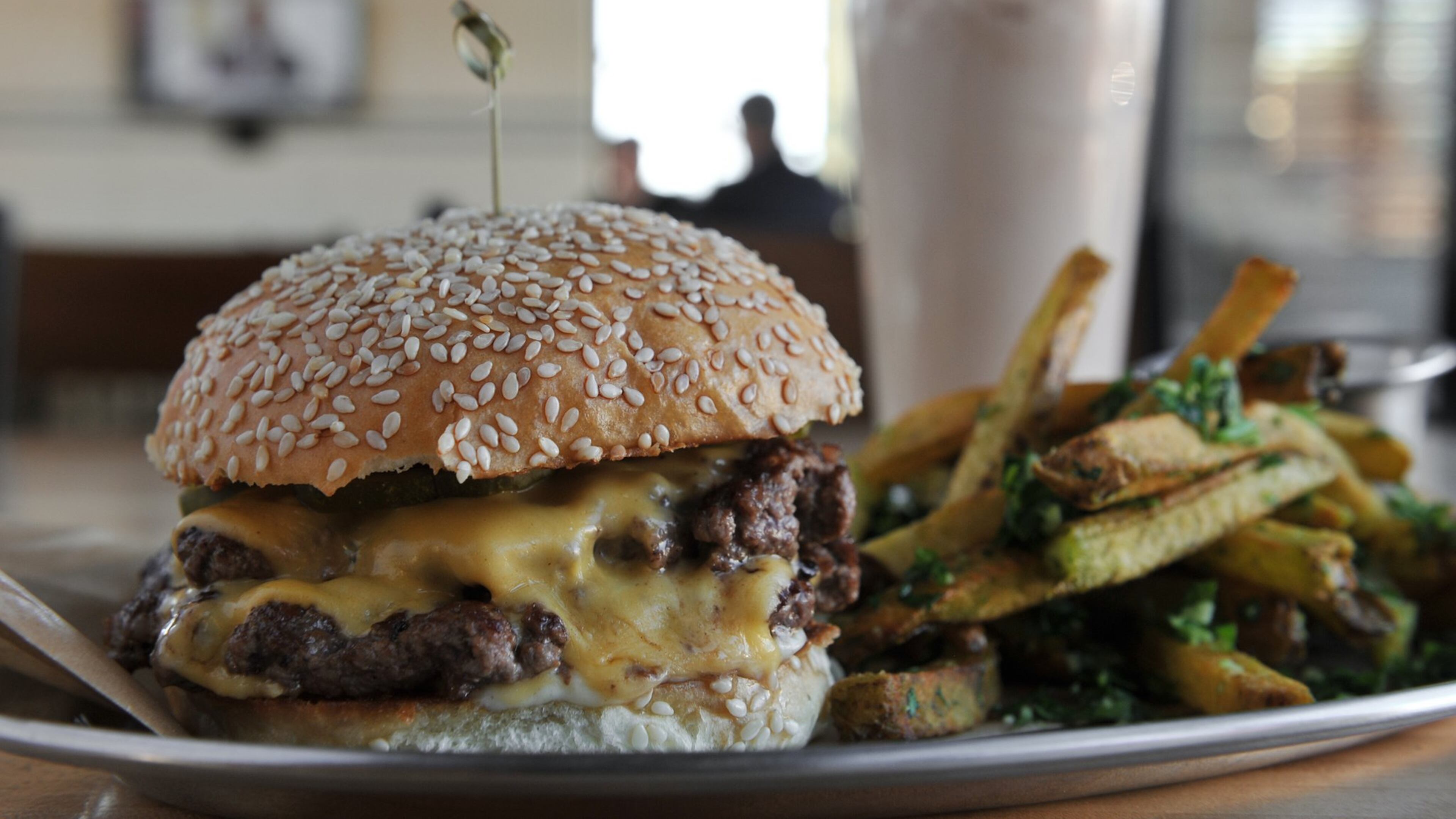 Bocado’s Burger Stack includes American cheese, pickle and, mayo, served here with herb fries and a chocolate shake.