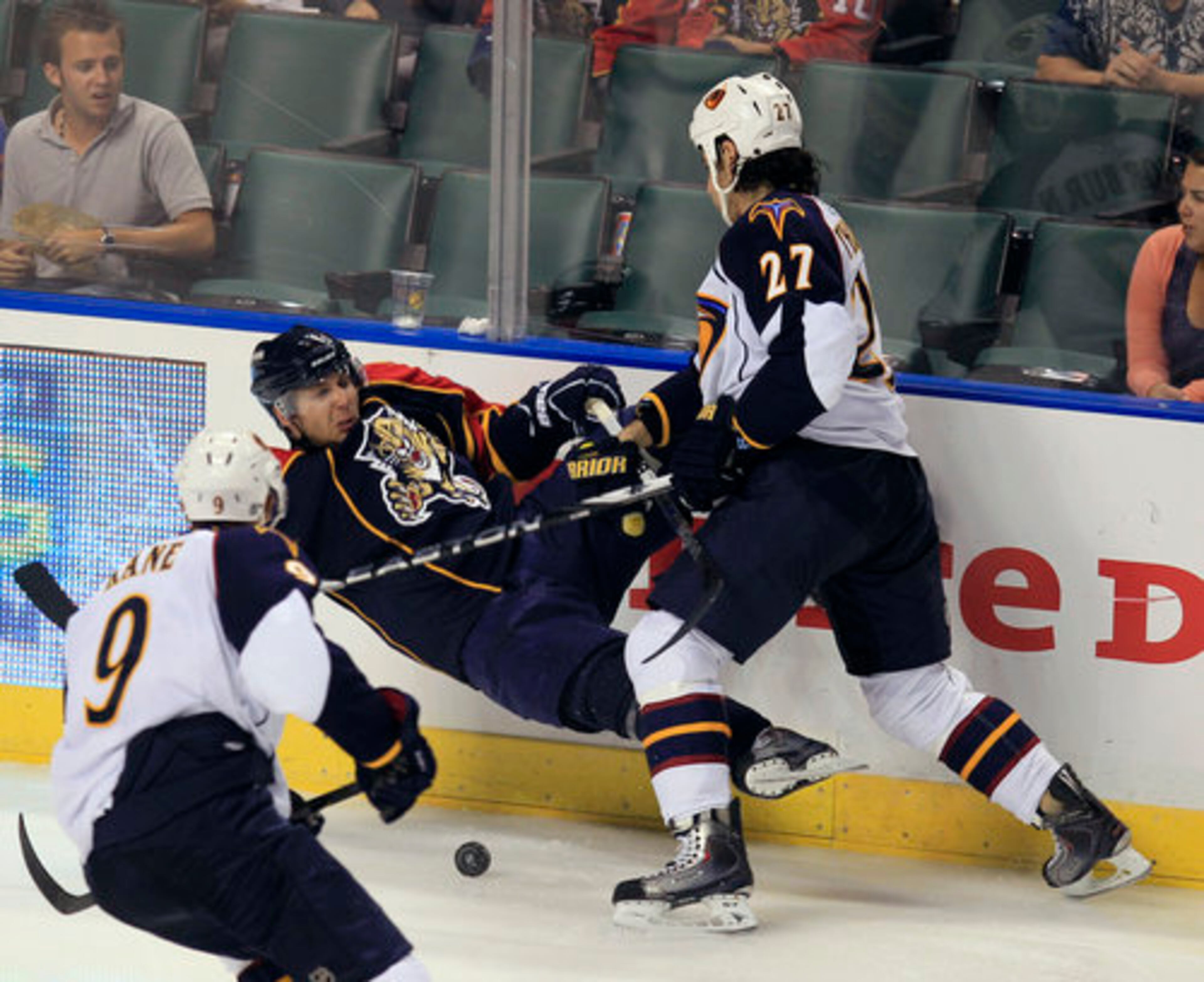 Florida Panthers' Steve Bernier is knocked to the ice by Atlanta Thrashers' Chris Thorburn (27) as Atlanta's Evander Kane approaches during the third period of an NHL hockey game in Sunrise, Fla. Wednesday, Nov. 3, 2010. The Thrashers won 4-3.