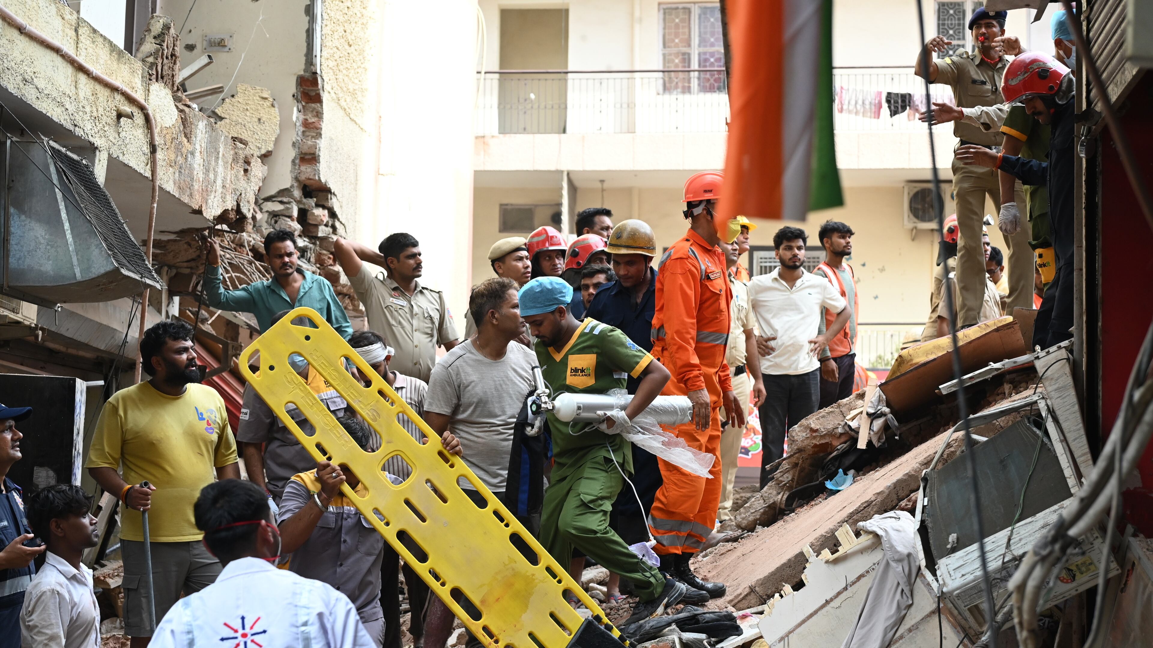 Rescue workers look for the trapped survivors under the debris of a building that collapsed in New Delhi, India, Sunday, Sept. 6, 2026. (AP Photo/ Vipin)