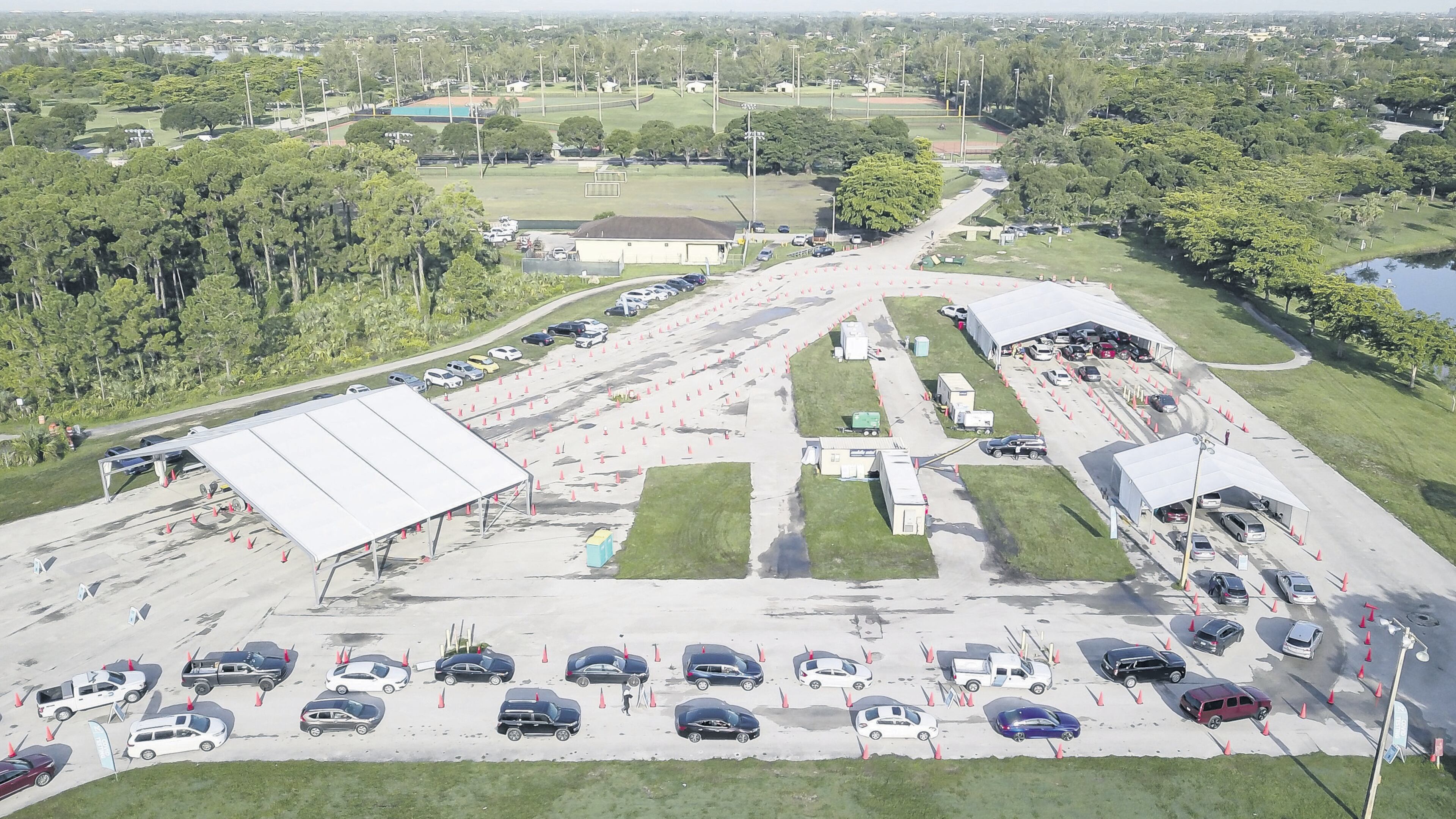 An aerial view shows cars lining up at Tropical Park's COVID-19 testing site in Miami. The new variant mu is believed to be even more transmissible than the delta variant and has the potential to resist vaccines, officials say. (Matias J. Ocner/Miami Herald/TNS)