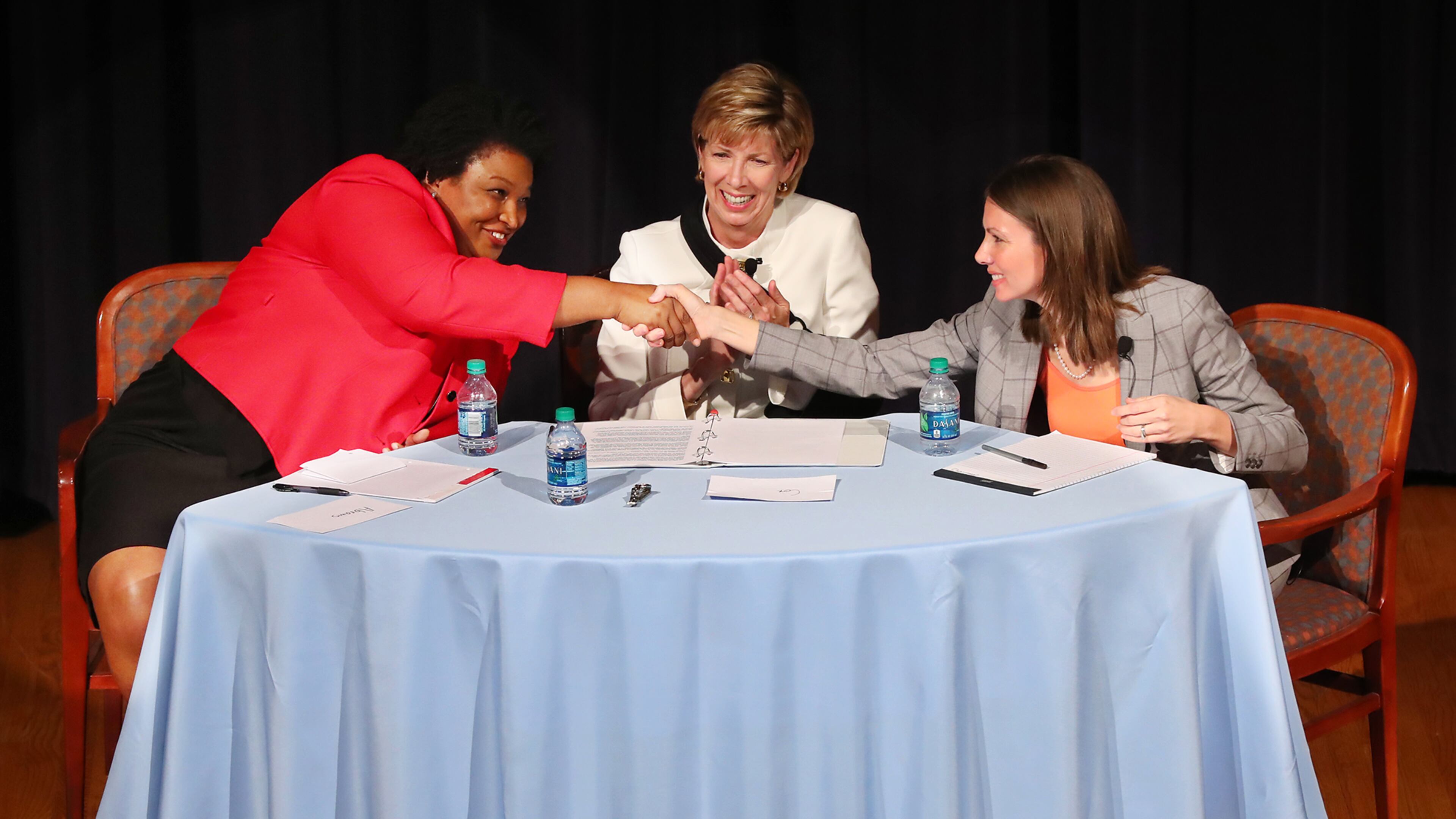 Democrats Stacey Abrams (left) and Stacey Evans (right) shake hands at the conclusion of their first forum in Atlanta. Curtis Compton/ccompton@ajc.com