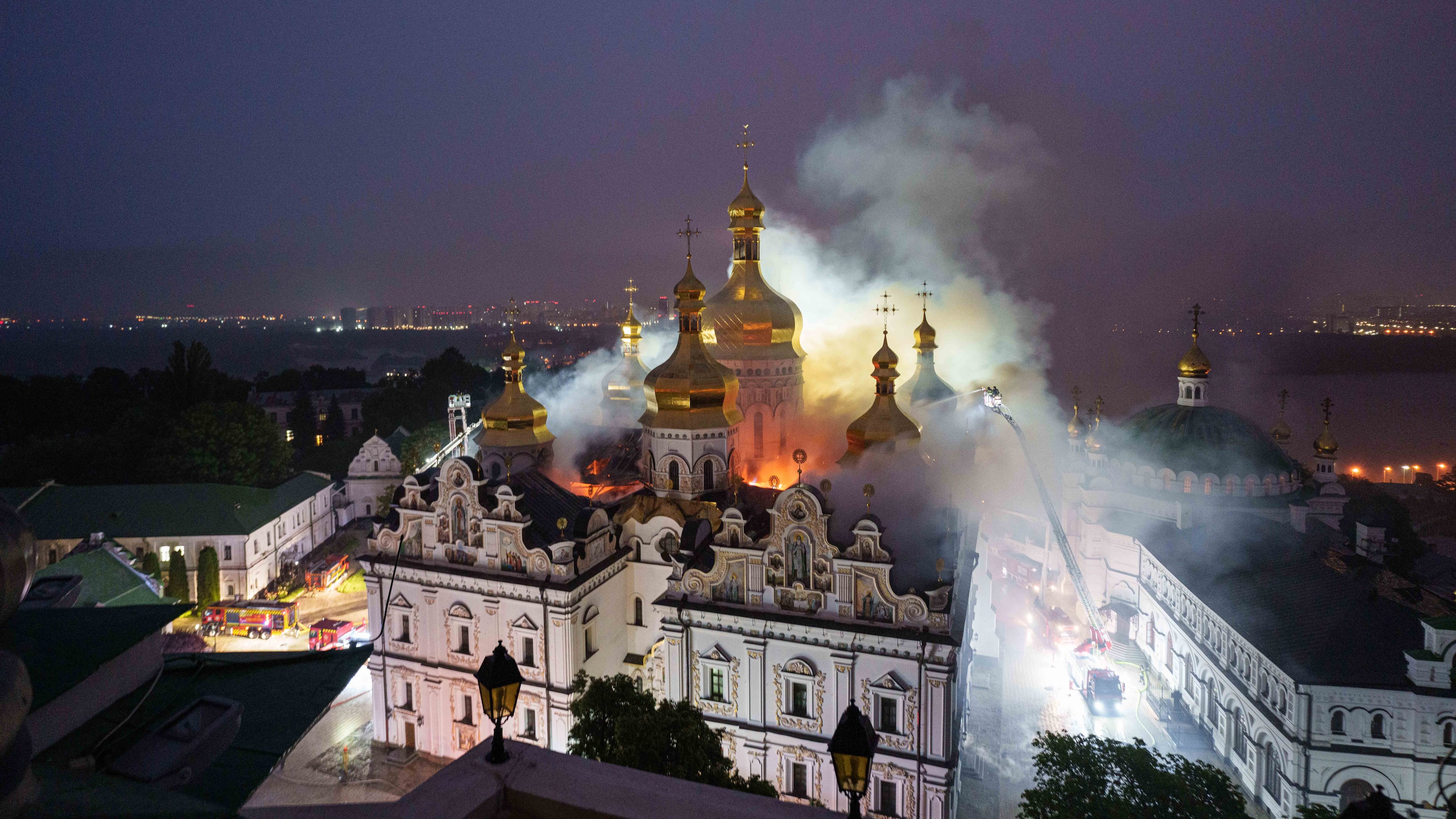 Rescue workers try to put out a fire at the Dormition Cathedral of thousand-year-old Monastery of Caves, also known as Kyiv Pechersk Lavra, following a Russian strike on Kyiv, Ukraine, Monday, June 15, 2026. (AP Photo/Evgeniy Maloletka)