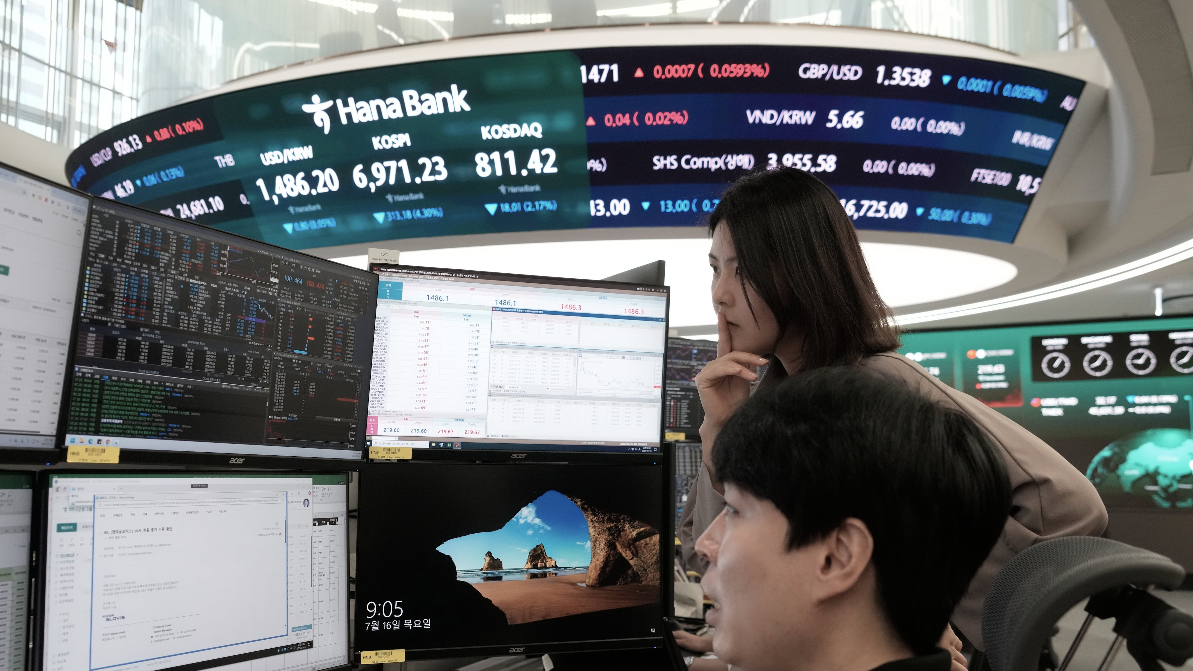 Currency traders watch monitors at the foreign exchange dealing room of the Hana Bank headquarters in Seoul, South Korea, Thursday, July 16, 2026. (AP Photo/Ahn Young-joon)