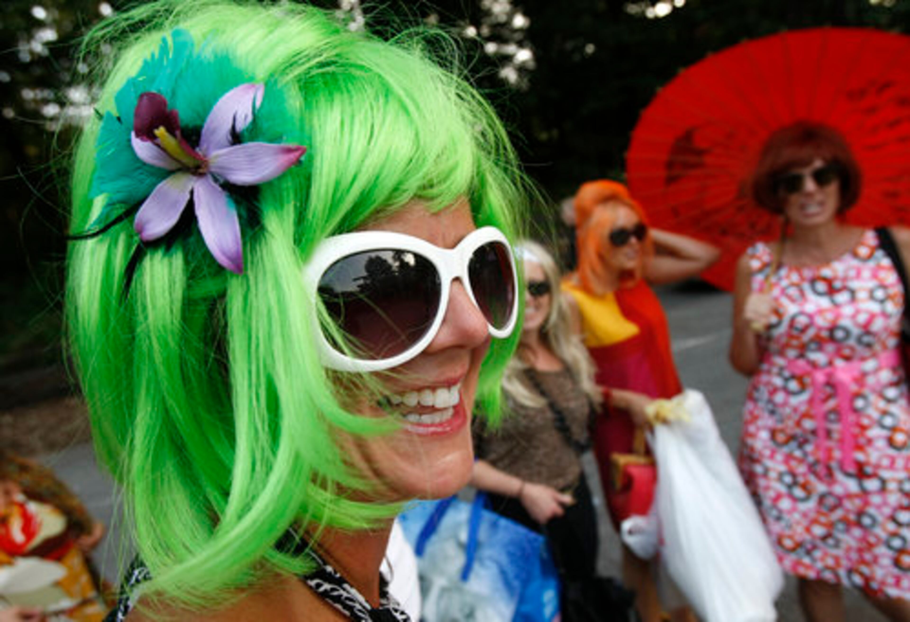 Sporting green hair, B-52s fan Tiffany McLaughlin, John's Creek, and friends, arrive for their concert at Chastain Park Amphitheater on Wednesday, August 25, 2010.
