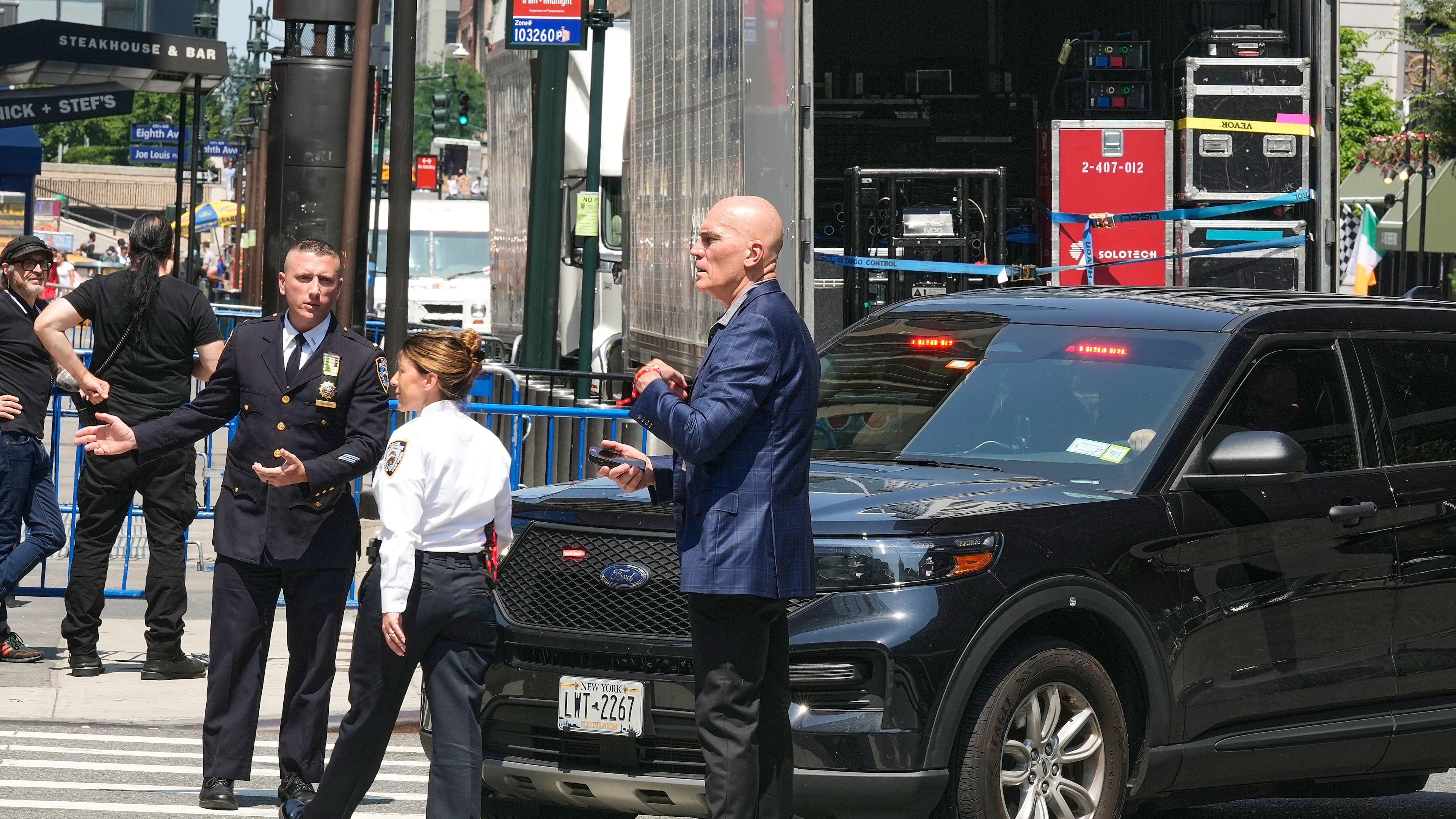 Security personnel meet outside New York's Madison Square Garden, Wednesday, July 1, 2026. (AP Photo/Richard Drew)