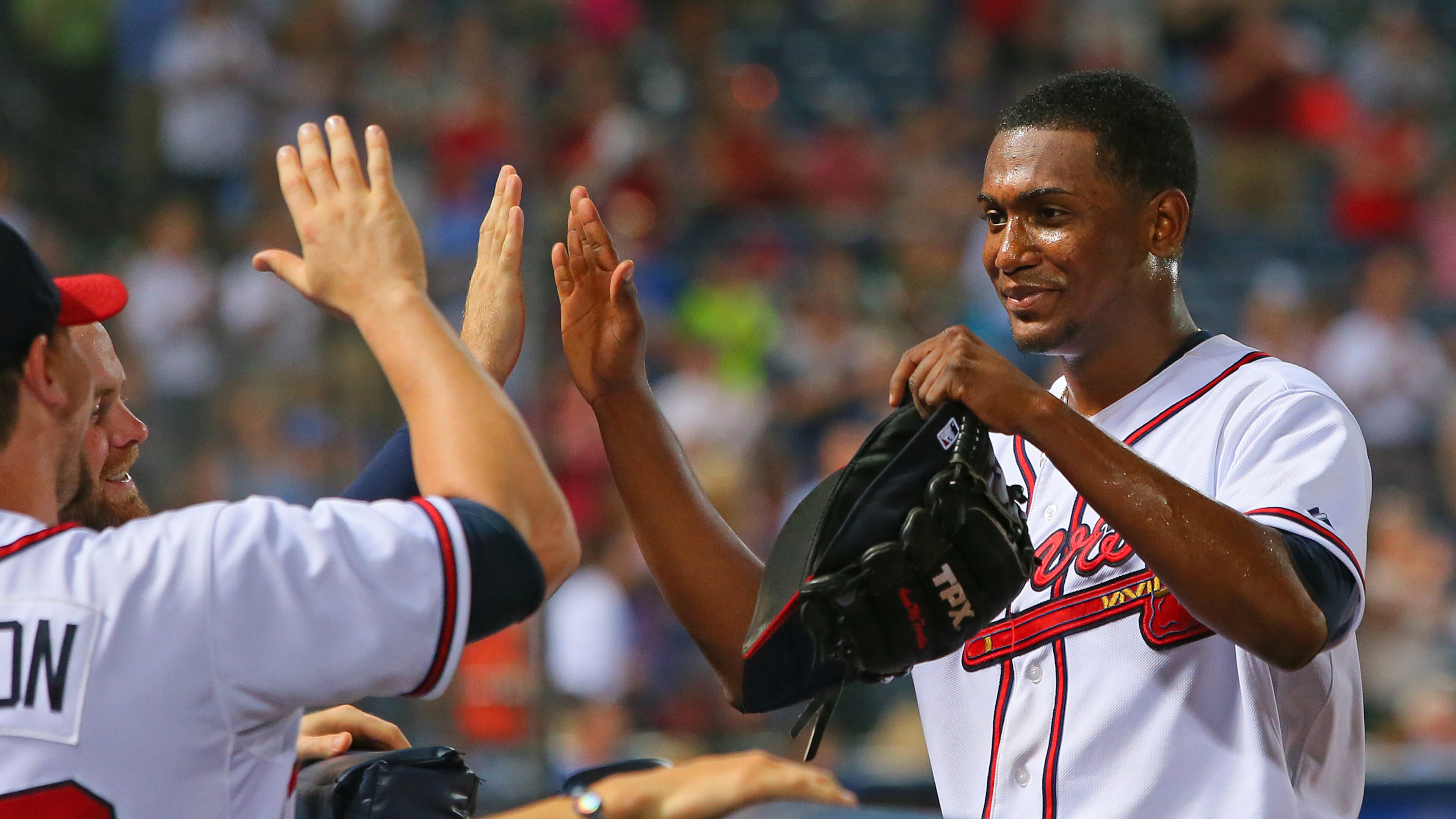 Julio Teheran pitched 8 1/3 innings against the Twins. He was congratulated by teammates as he left the game on Monday, May 20, 2013, in Atlanta.