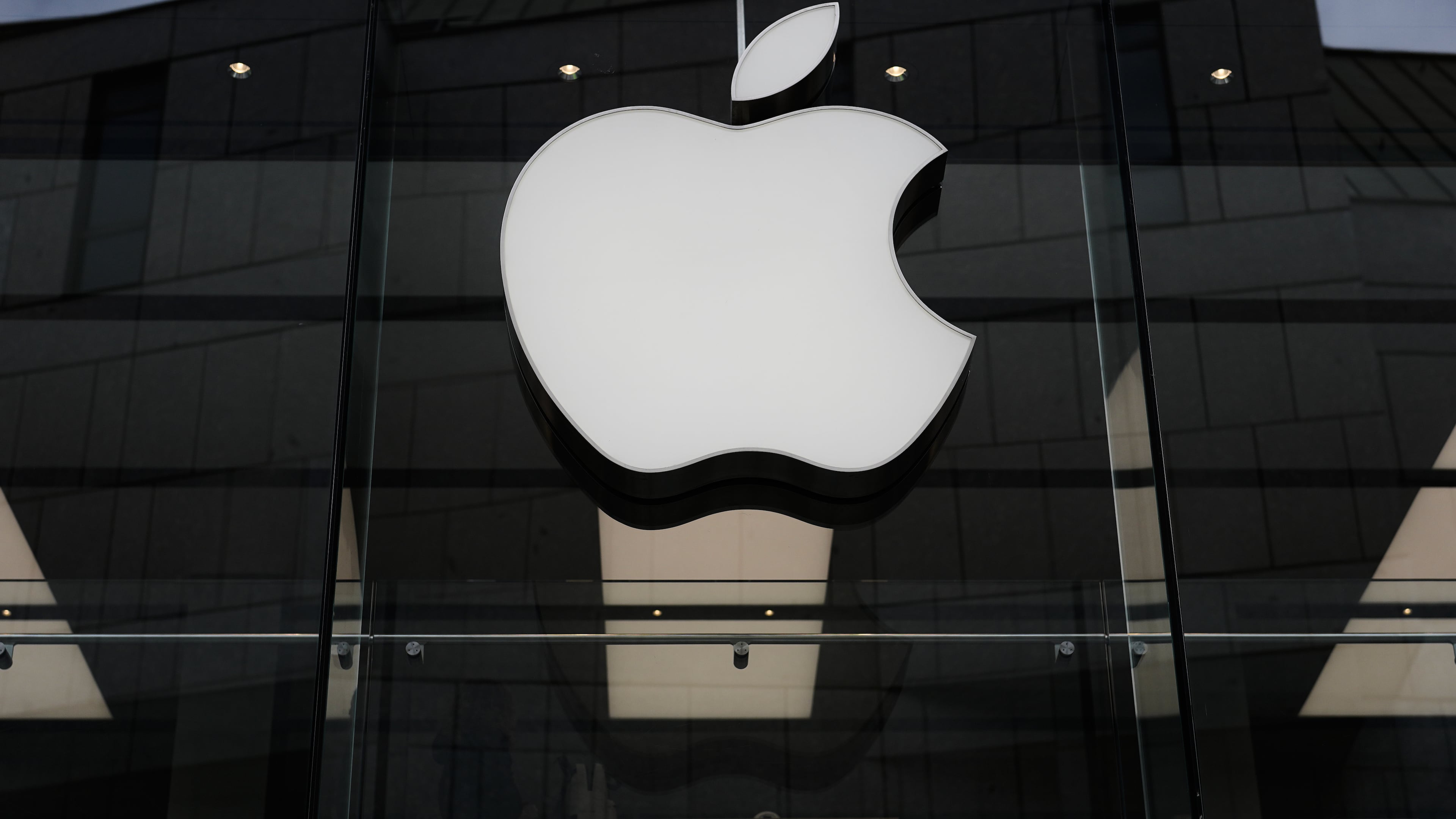FILE - The Apple logo is illuminated at a store in Munich, Germany, April 2, 2026. (AP Photo/Matthias Schrader, File)