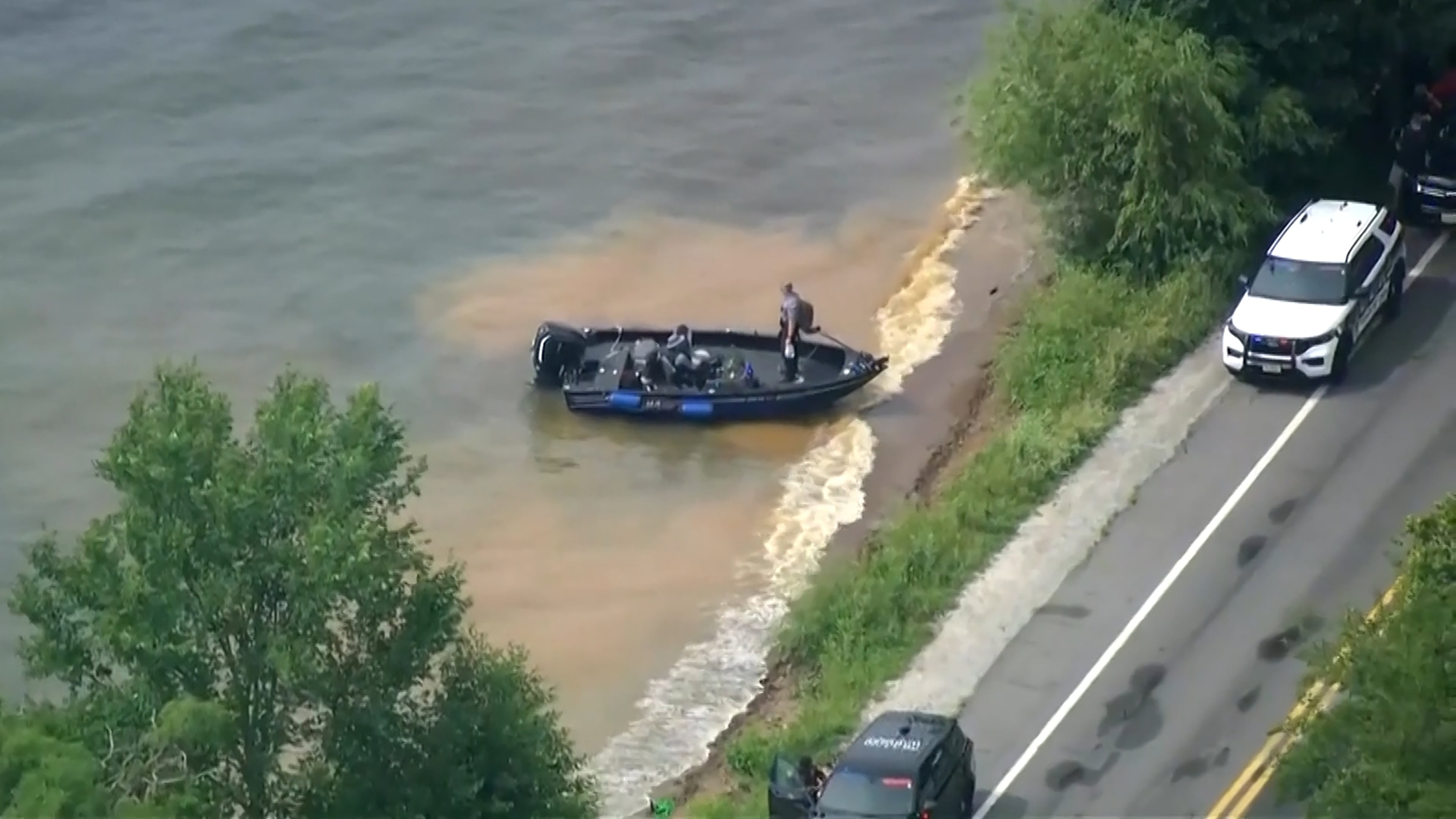 This image made from video provided by WISN-TV shows law enforcement use search boats in Geneva Lake, Wis., after receiving calls of an overturned boat on Friday, July 3, 2026. (WISN-TV via AP)