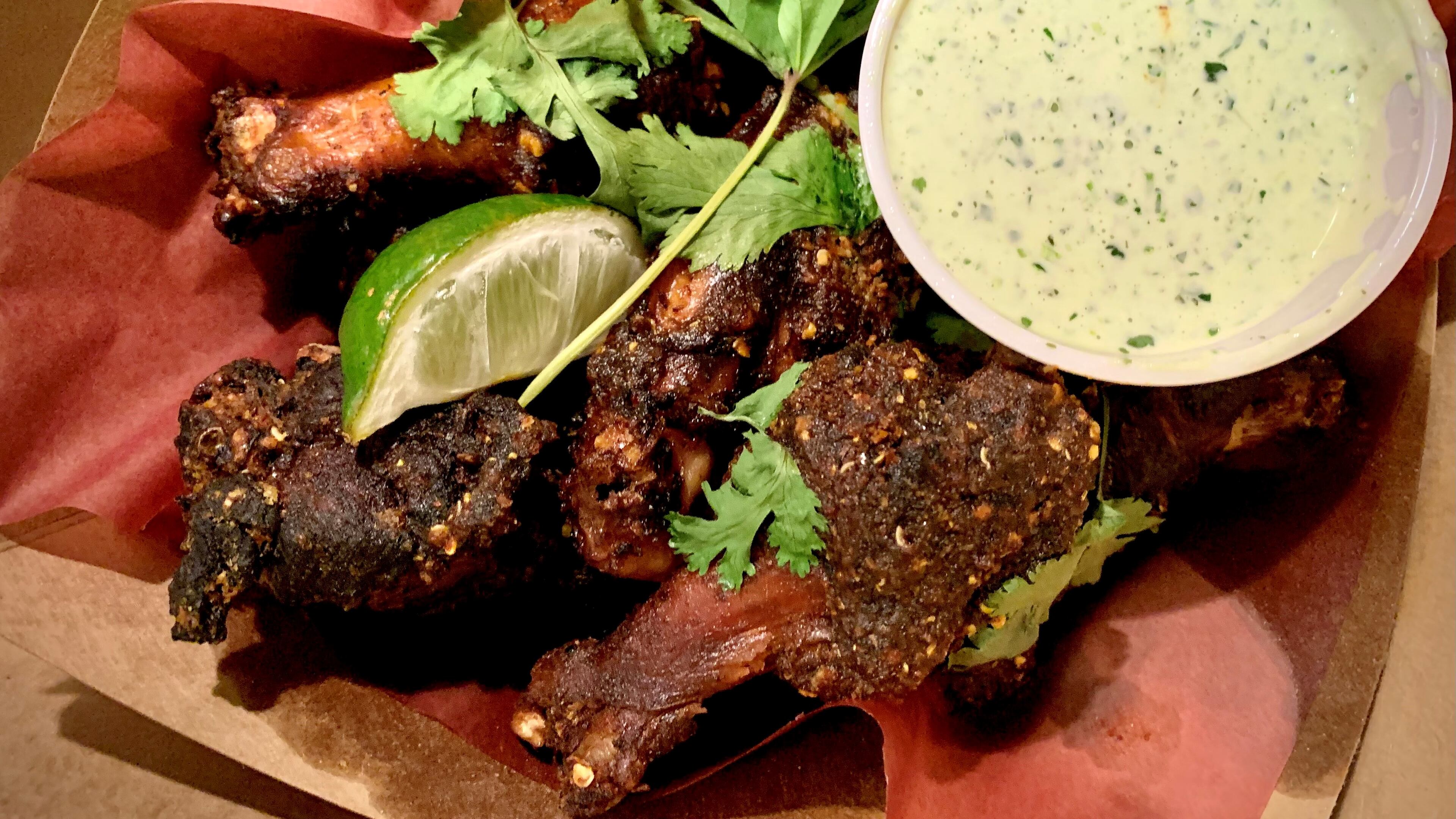 The smoked wings at Little Rey are dressed with salsa macha, a mixture of dried chiles and peanuts. Henri Hollis/henri.hollis@ajc.com