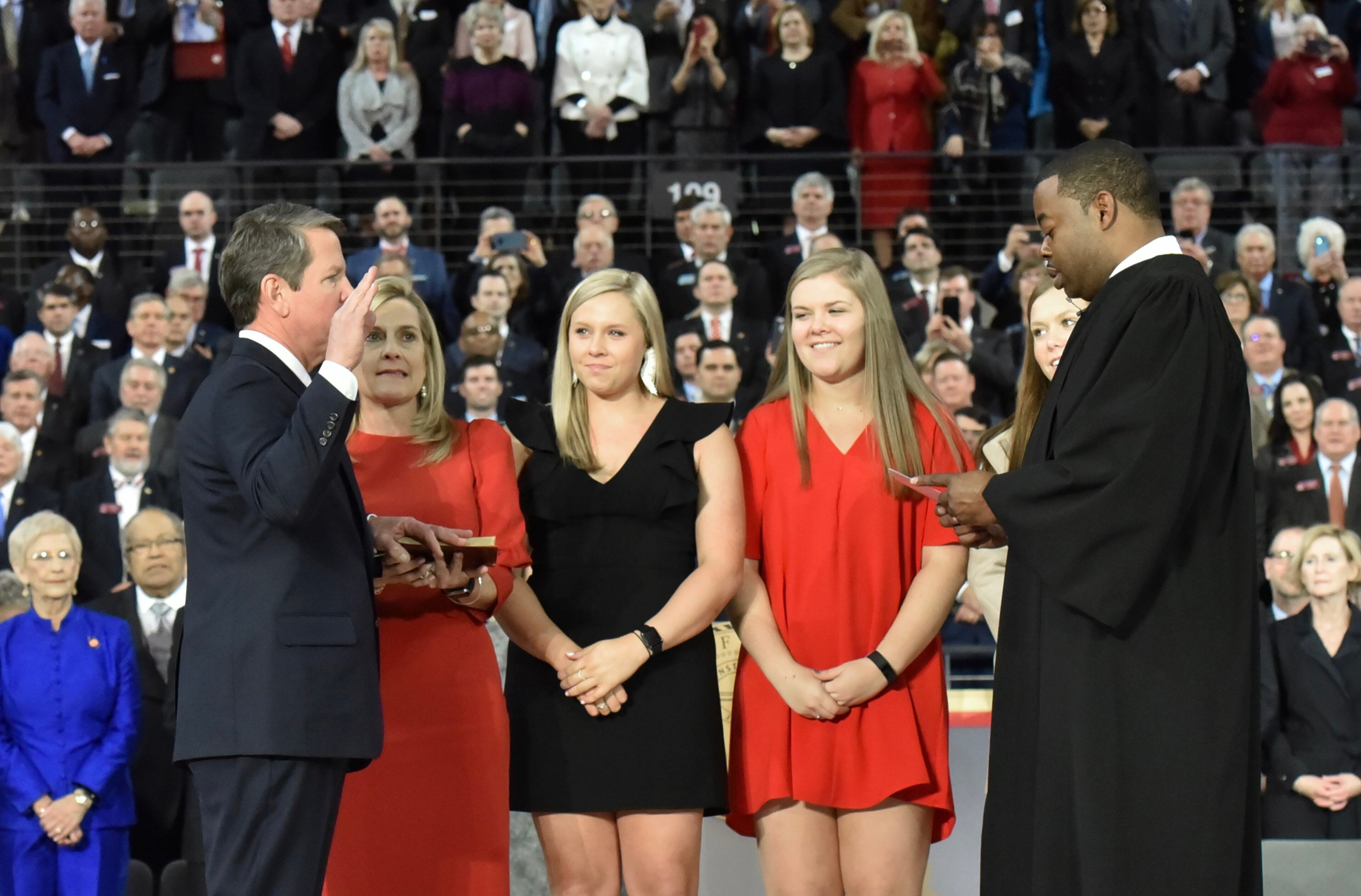 January 14, 2019 Atlanta - Brian Kemp with wife Marty Kemp, holding the bible, takes the oath of office from the Honorable T.J. Hudson during the swearing-in ceremony at McCamish Pavilion in Campus of Georgia Tech on Monday, January 14, 2019. HYOSUB SHIN / HSHIN@AJC.COM