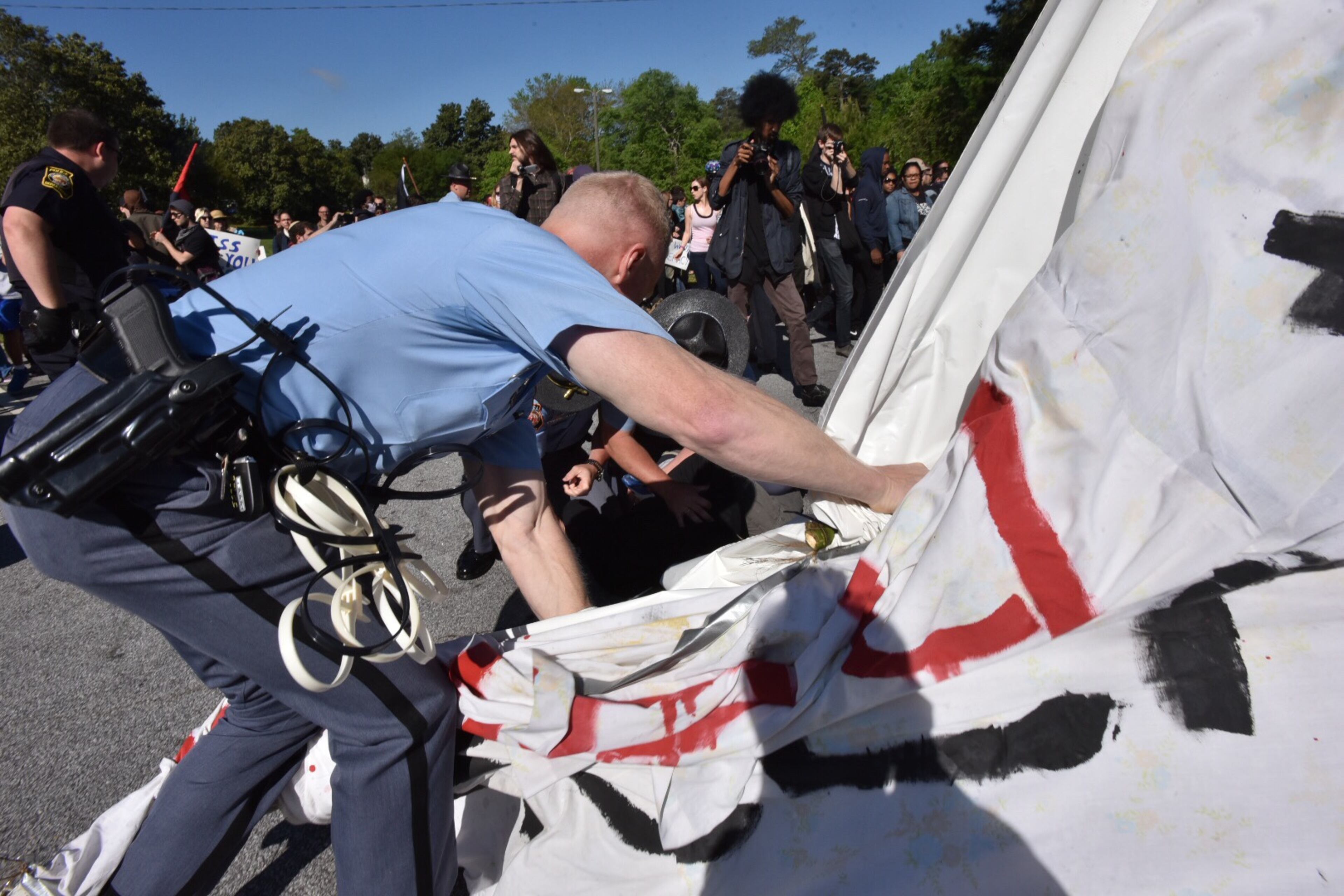 Protesters clash with police near a “white power” rally in Stone Mountain on Saturday, April 23, 2016. The protesters said they are opposing the message of hate at the supremacist rally also taking place at the park.